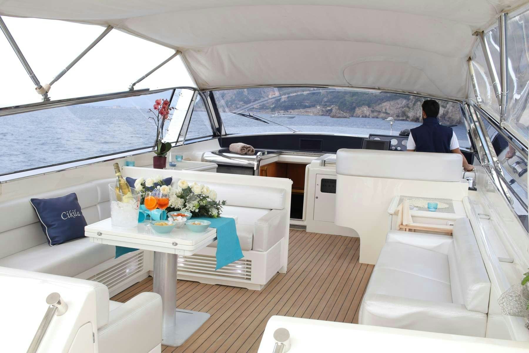 a boat with a table and chairs aboard CIKILA Yacht for Charter