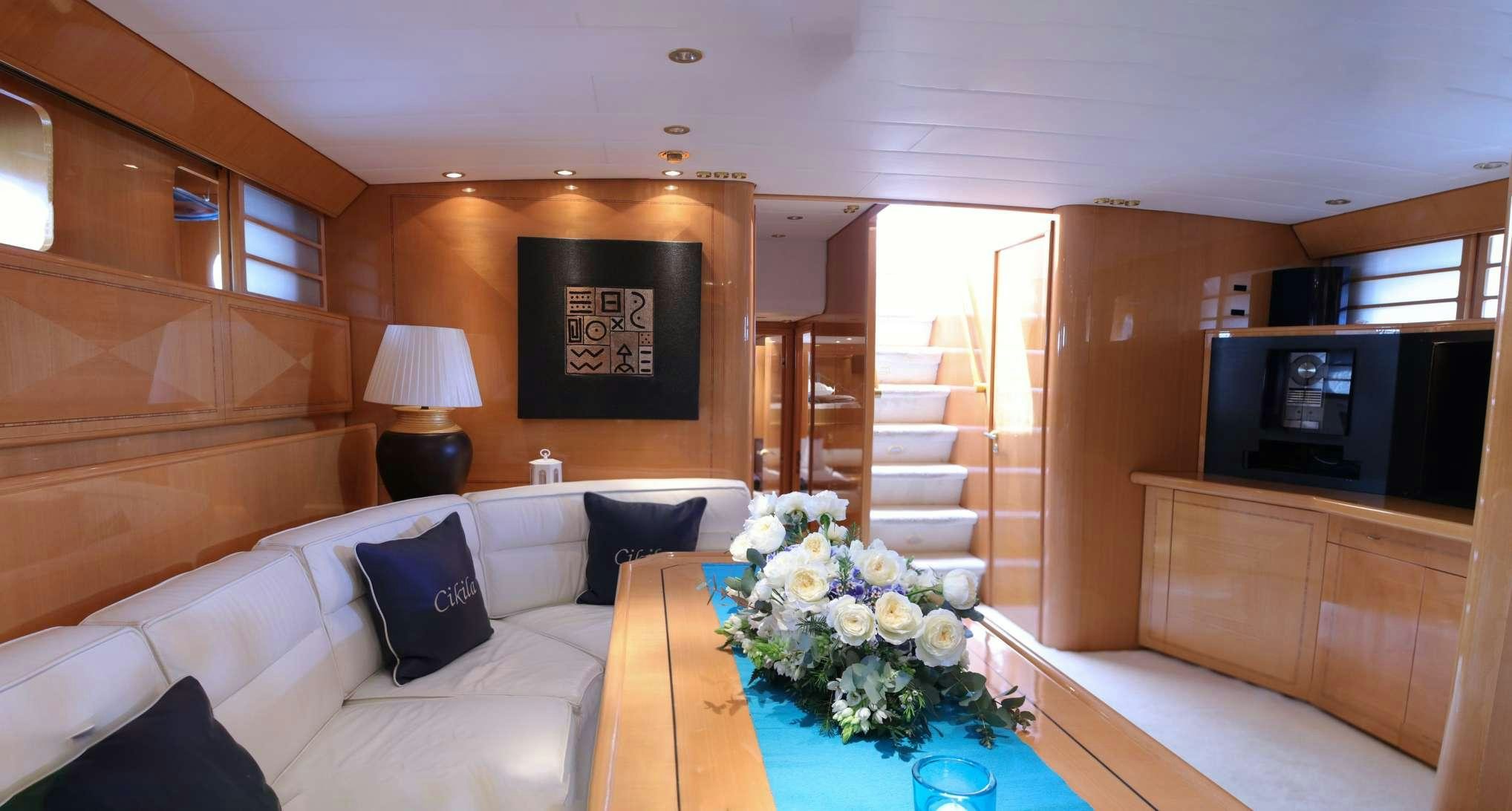 a living room with a white couch and a table aboard CIKILA Yacht for Charter