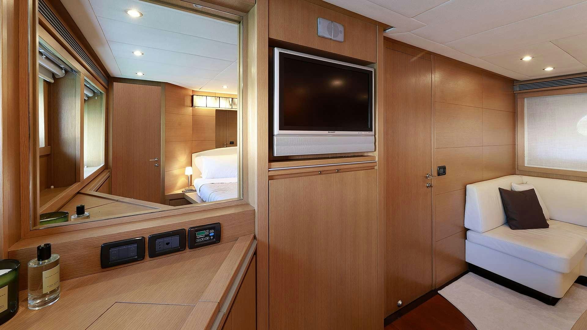 a room with a tv and a bed aboard PHOENIX Yacht for Charter