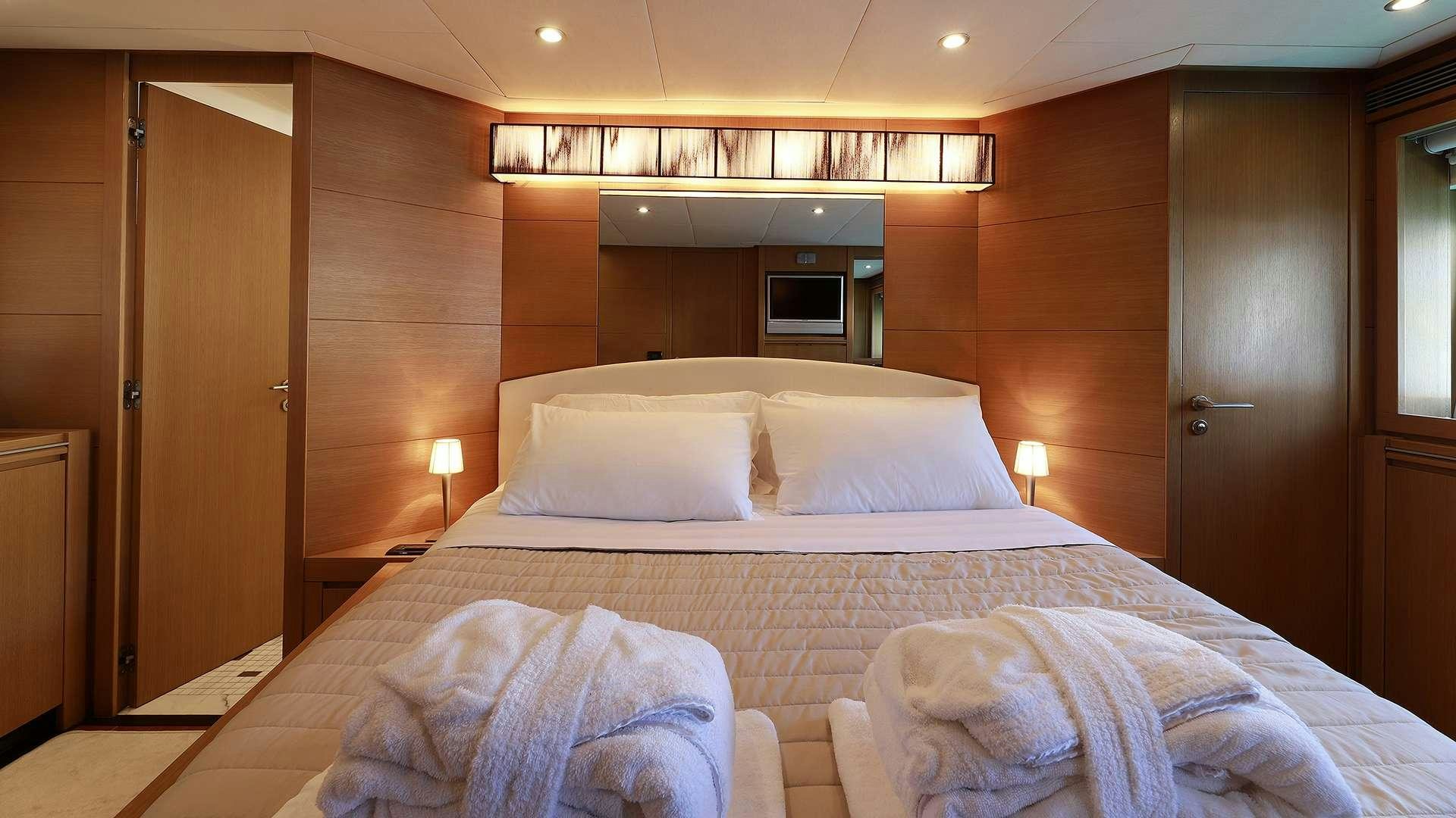 a hotel room with a bed aboard PHOENIX Yacht for Charter