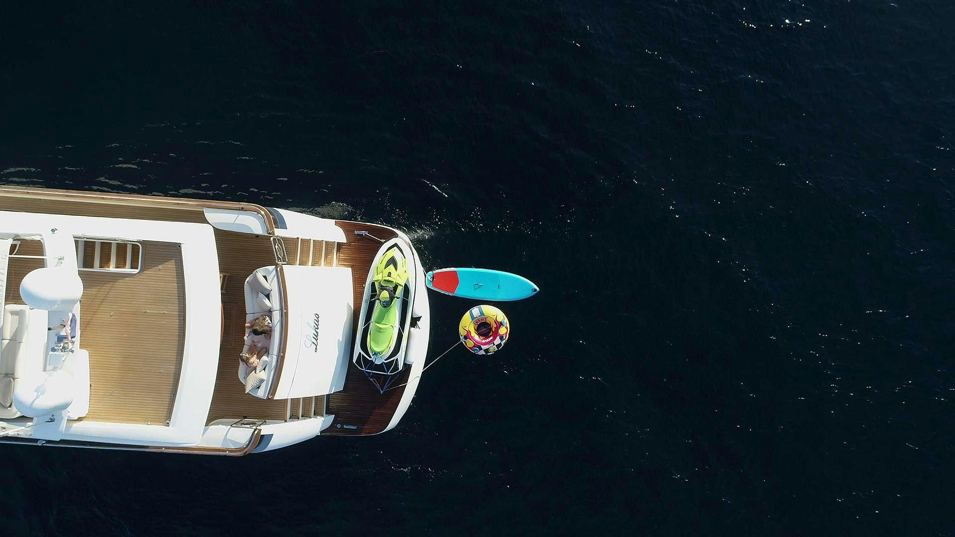 a white trailer with a blue and red surfboard on it aboard PHOENIX Yacht for Charter