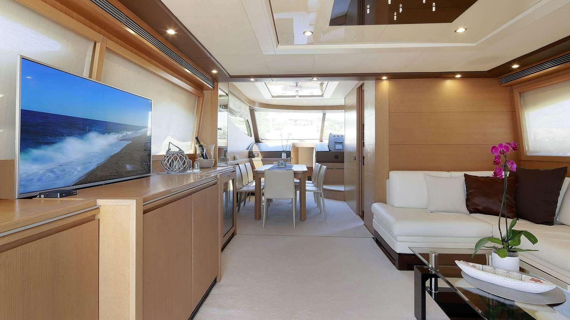 a room with a tv and a table aboard PHOENIX Yacht for Charter