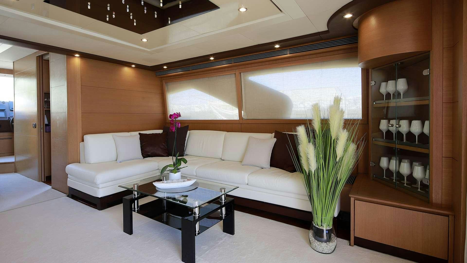a living room with a white couch and a coffee table aboard PHOENIX Yacht for Charter