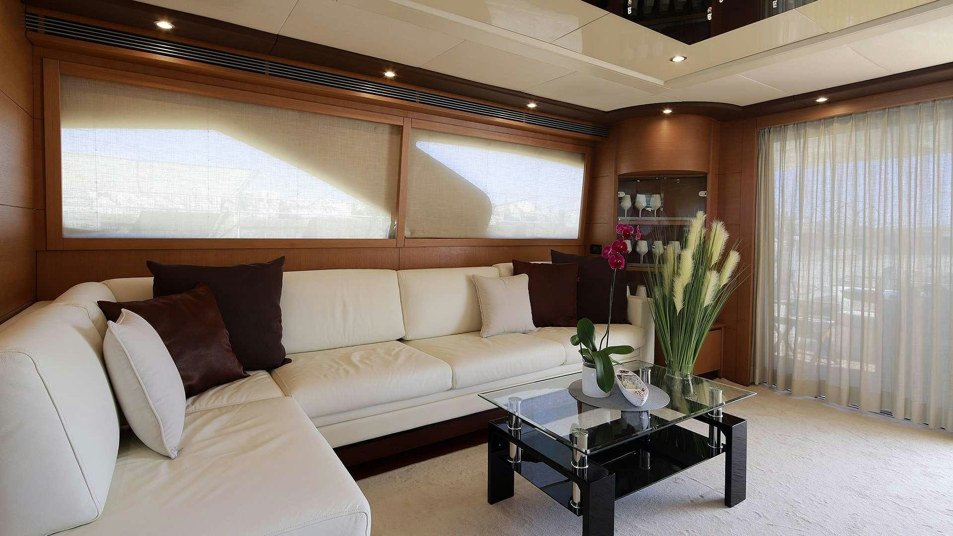 a living room with a white couch and a coffee table aboard PHOENIX Yacht for Charter