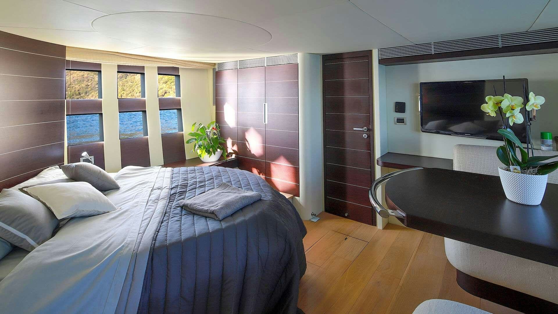 a bedroom with a bed and a tv aboard M/Y MAORO Yacht for Charter
