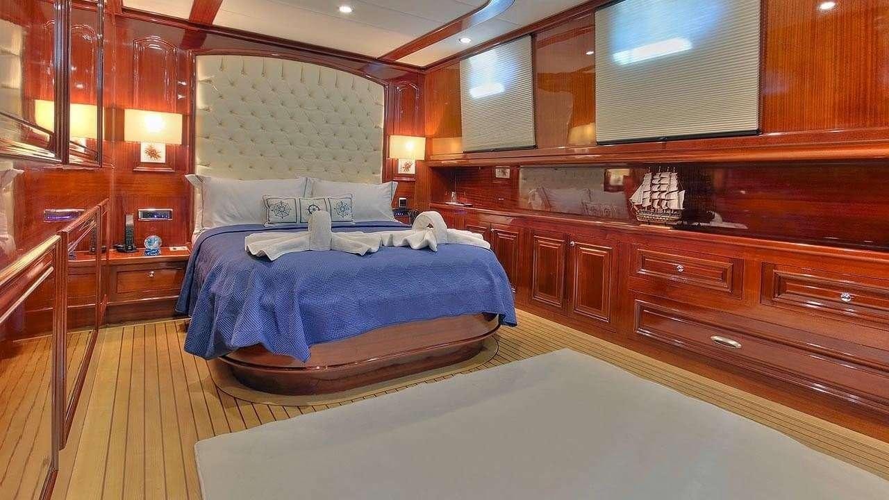 a room with wooden cabinets and a bed aboard PERFORMANCE FEE Yacht for Charter