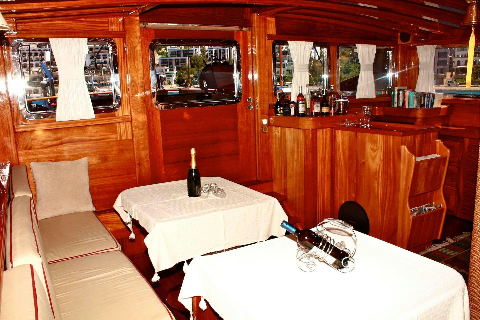 a table with a bottle of wine aboard IL FRATELLO Yacht for Charter