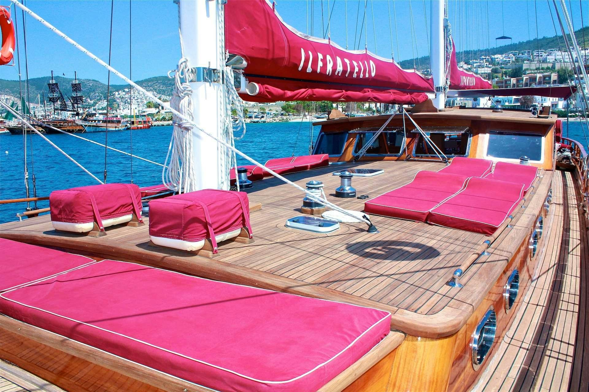 a boat with red seats aboard IL FRATELLO Yacht for Charter