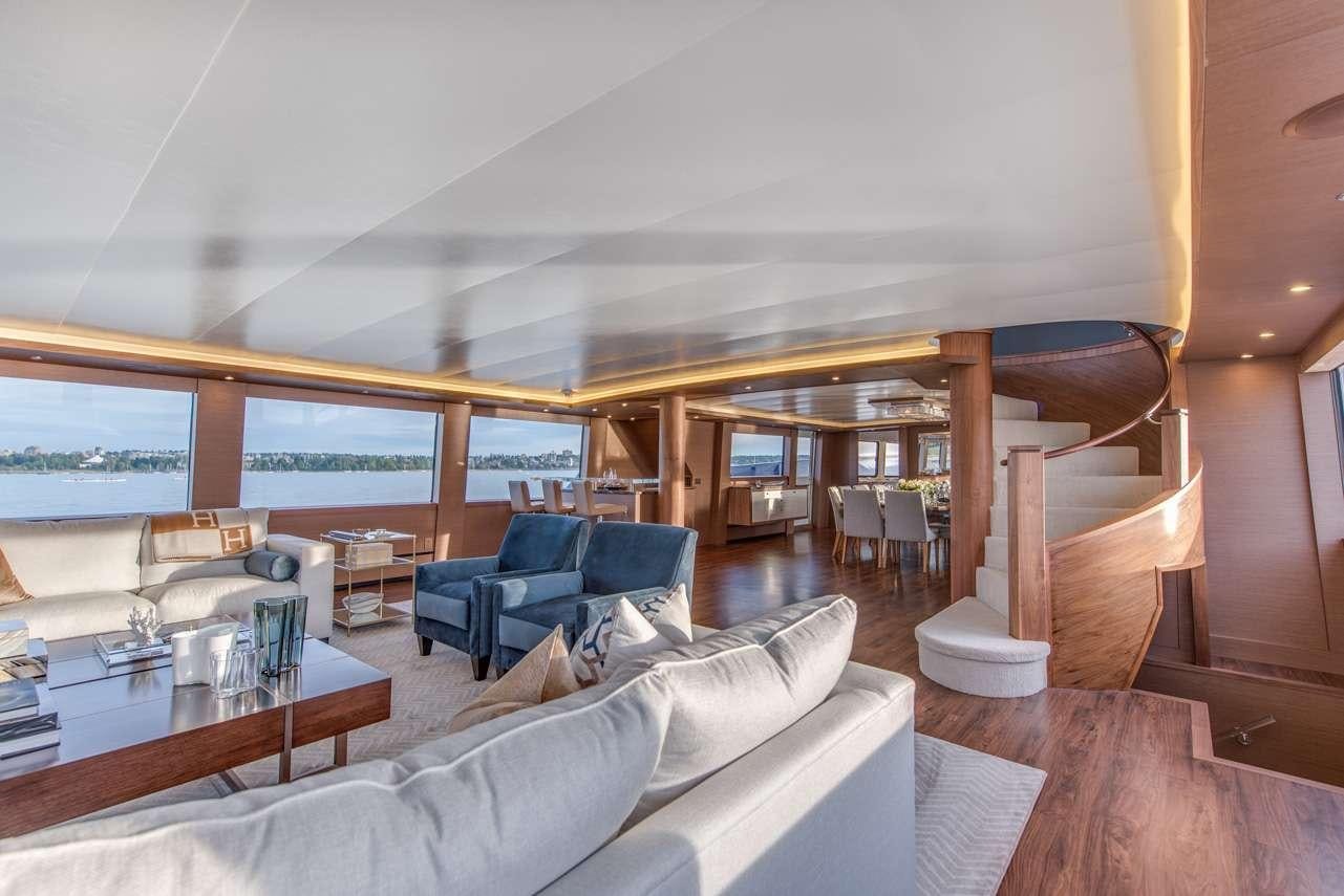 a living room with a large window aboard ASCENTE Yacht for Charter