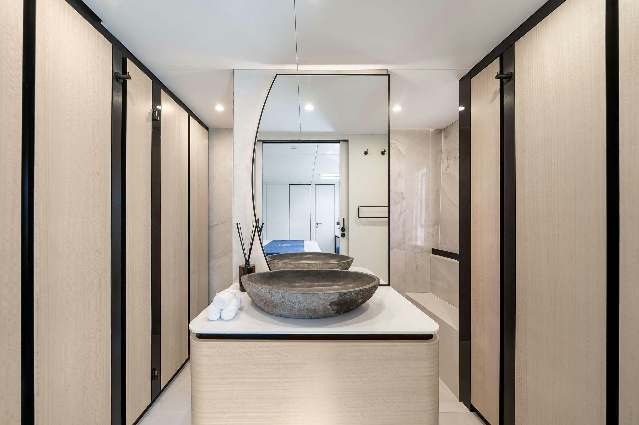 a bathroom with a sink and a mirror aboard ONE PLANET Yacht for Charter