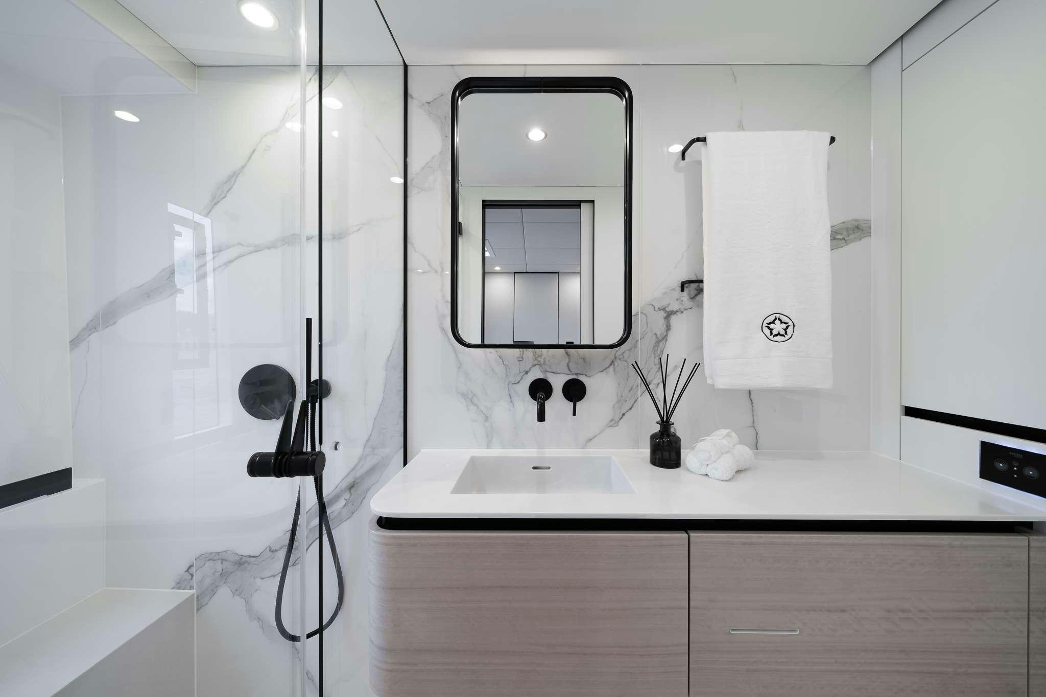 a bathroom with a glass shower aboard ONE PLANET Yacht for Charter