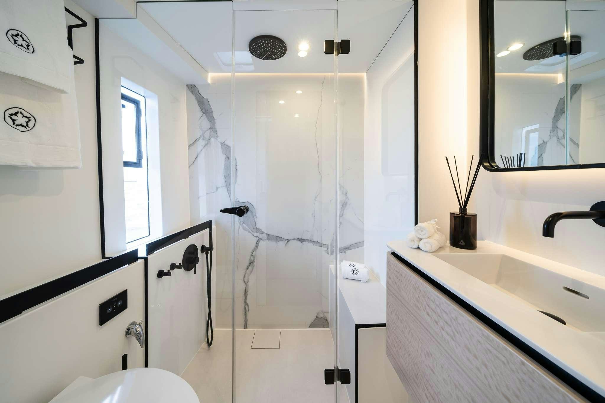 a bathroom with a shower and sink aboard ONE PLANET Yacht for Charter