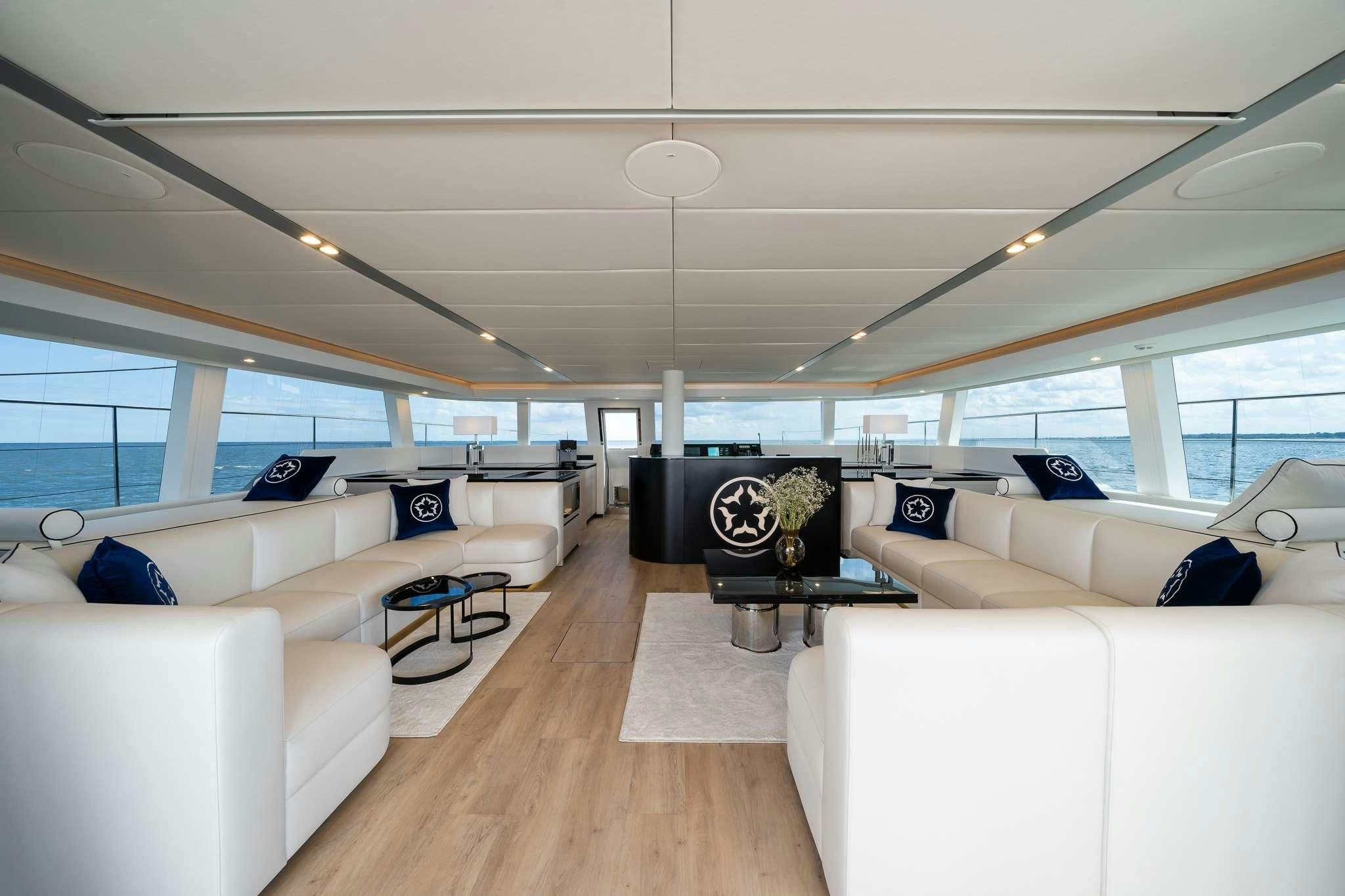 a room with a couch and a table aboard ONE PLANET Yacht for Charter