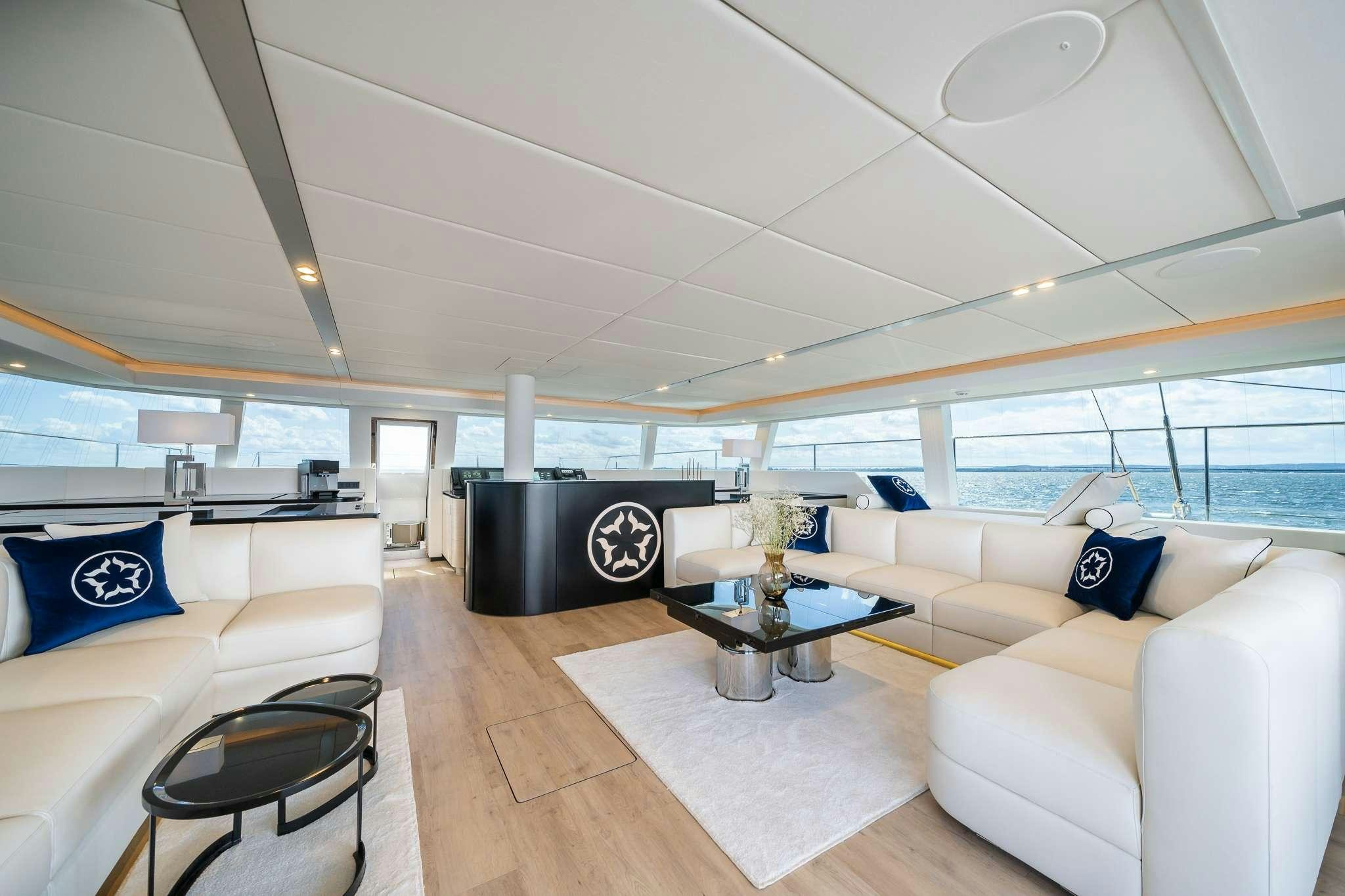 a living room with a large window aboard ONE PLANET Yacht for Charter