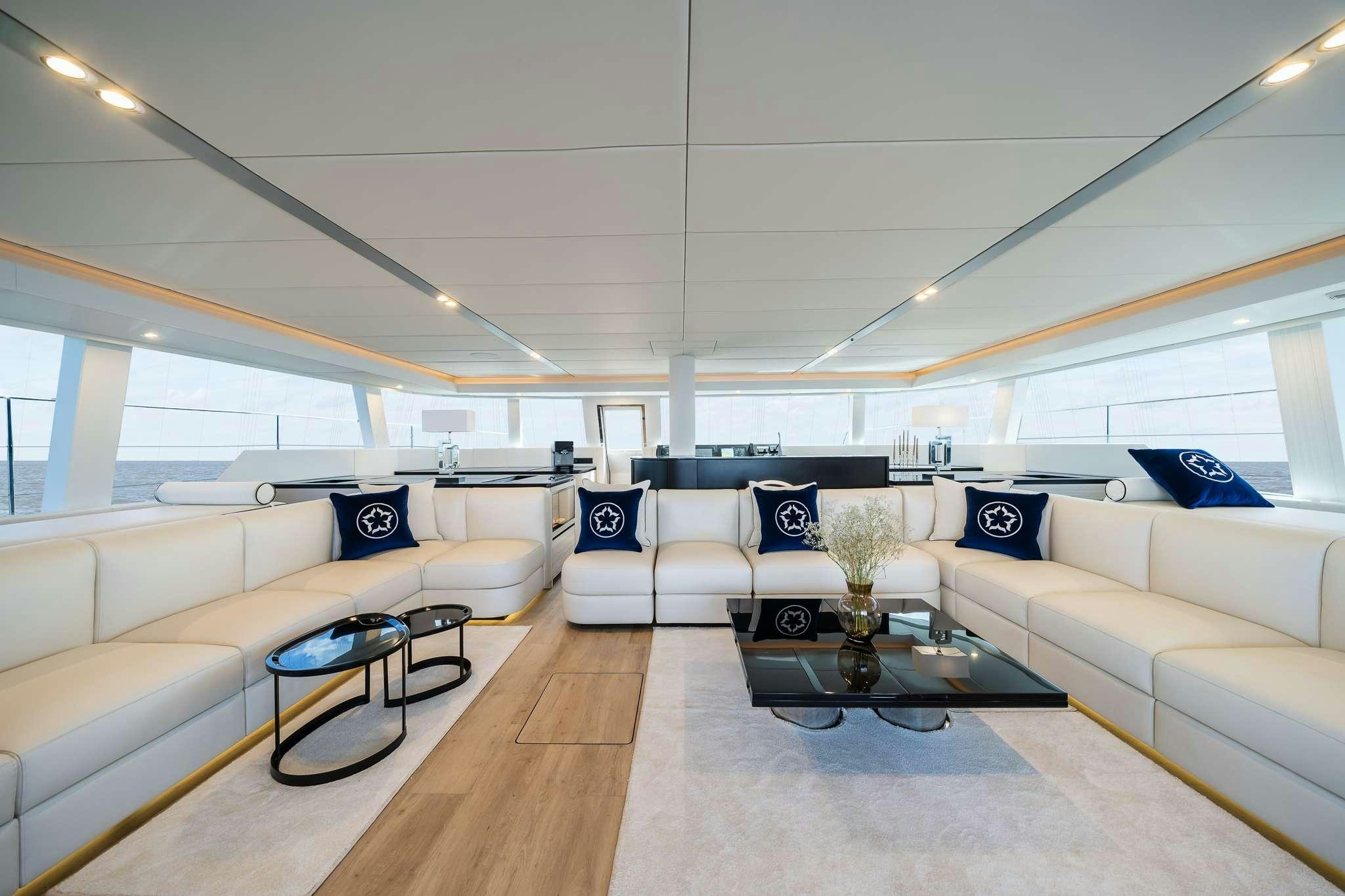 a living room with a large window aboard ONE PLANET Yacht for Charter