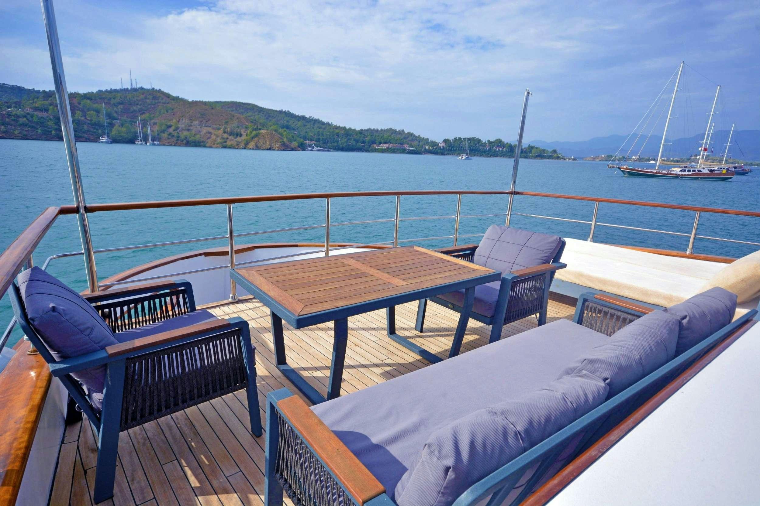 a table and chairs on a boat aboard NAYK 3 Yacht for Charter