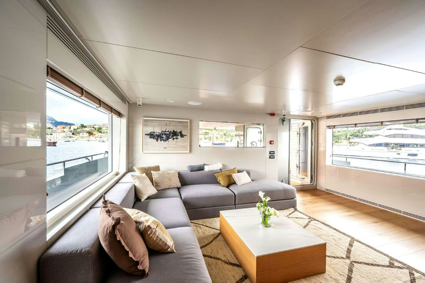 a living room with a large window aboard SO'MAR Yacht for Charter