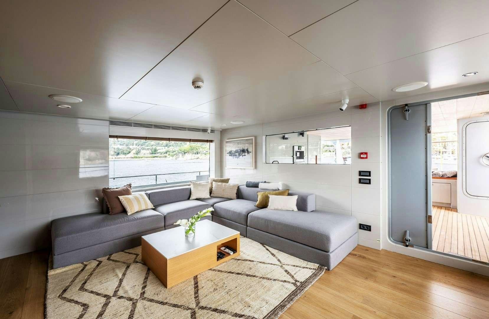 a living room with a couch and a coffee table aboard SO'MAR Yacht for Charter