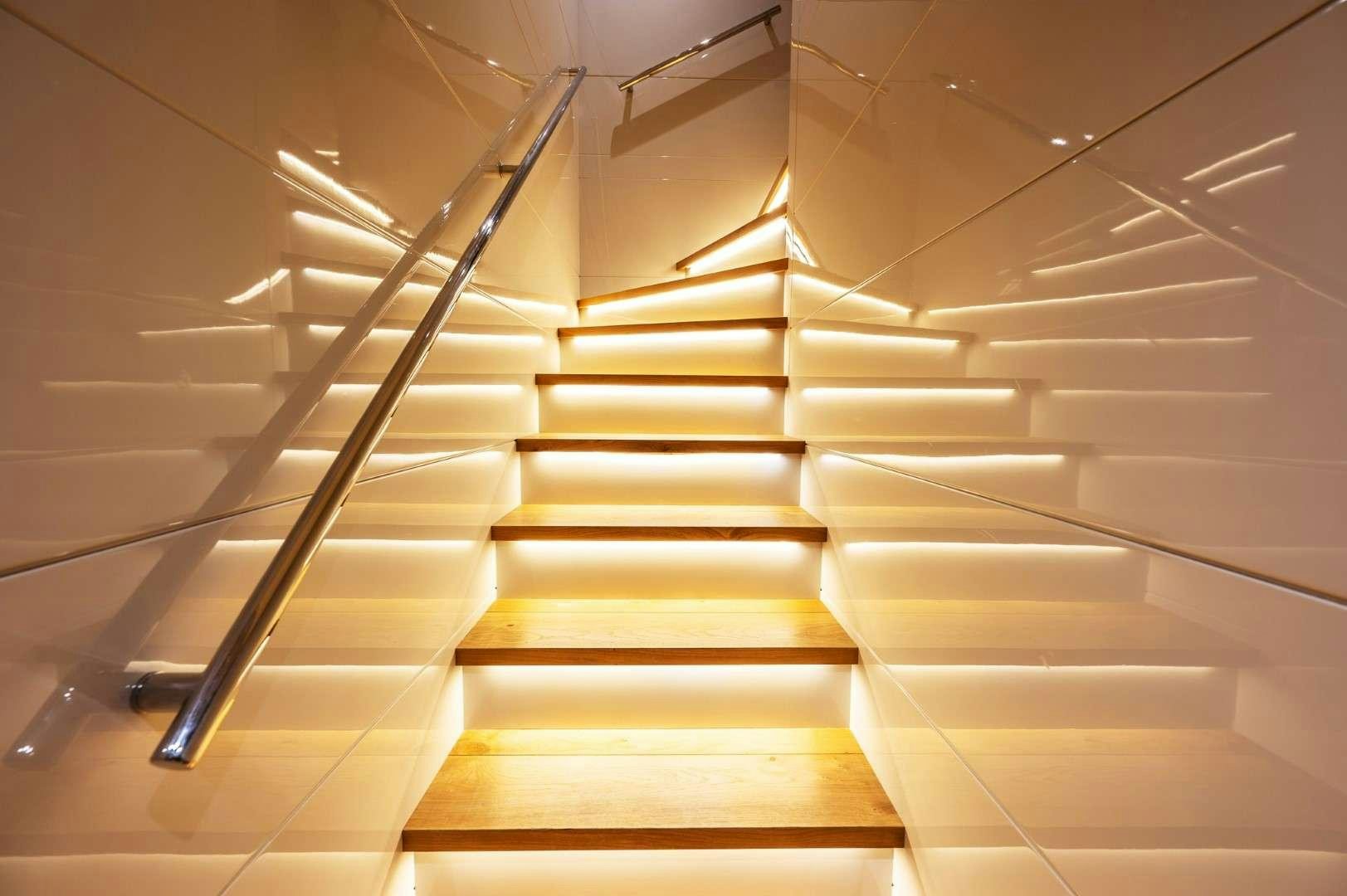 a staircase with a light aboard SO'MAR Yacht for Charter