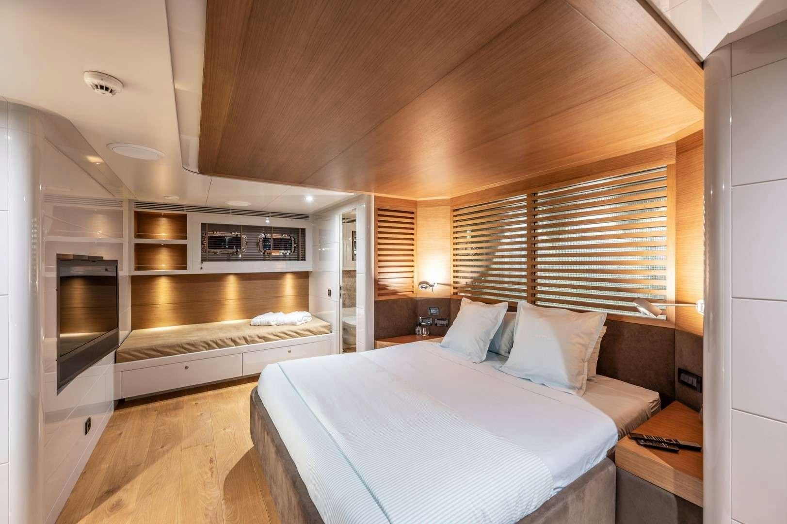 a bedroom with a bed and a microwave aboard SO'MAR Yacht for Charter