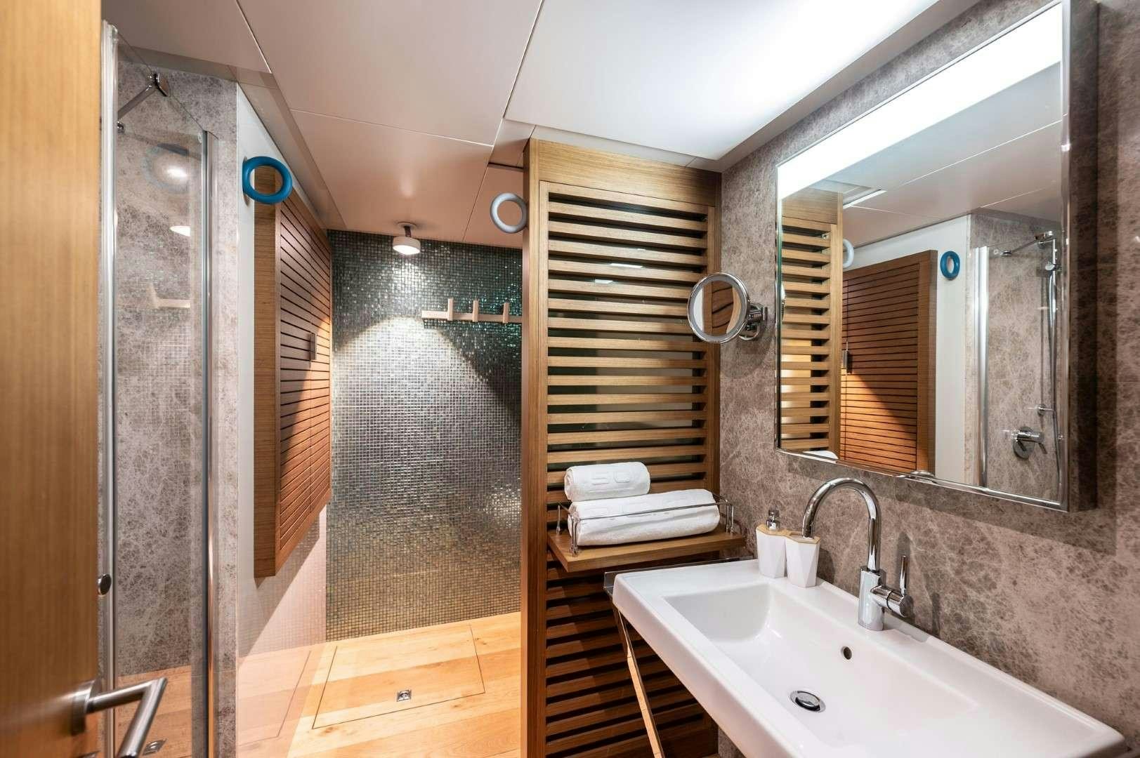 a bathroom with a sink and a mirror aboard SO'MAR Yacht for Charter