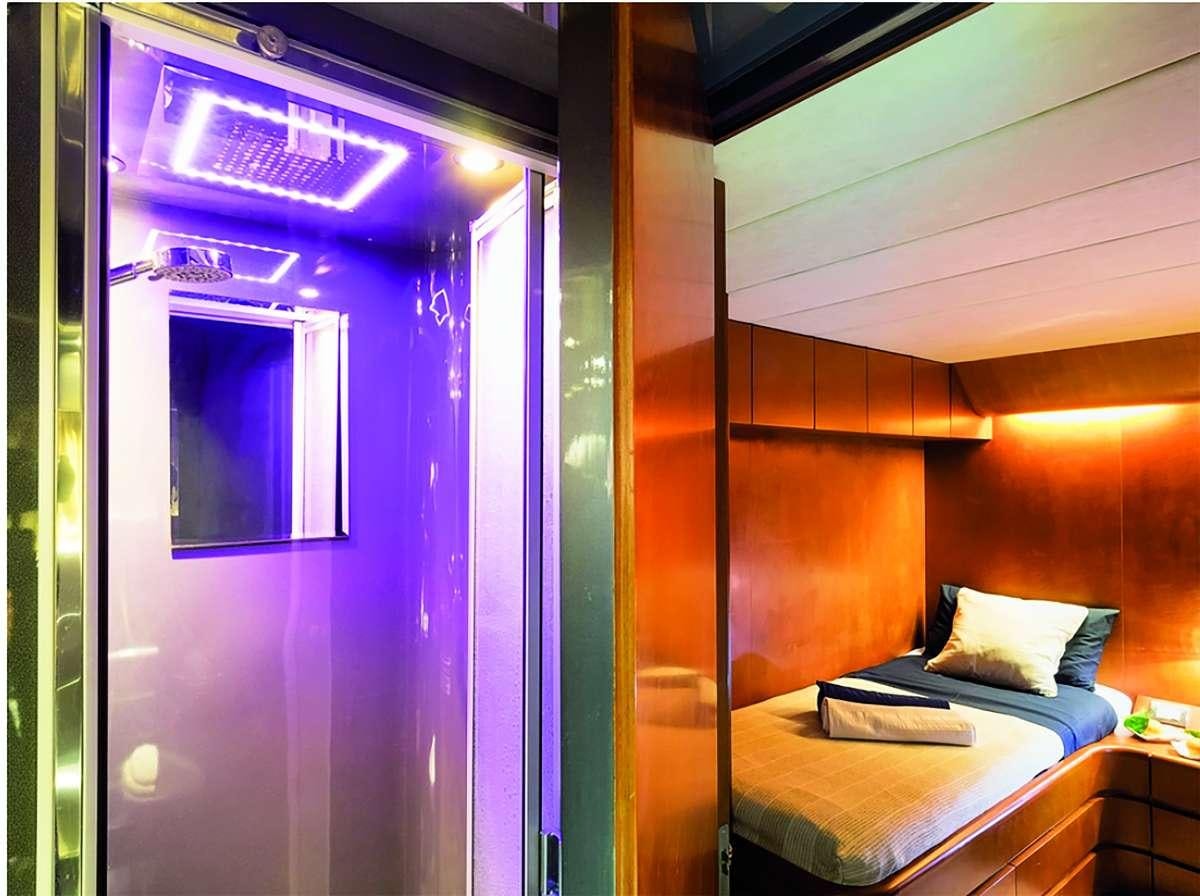 a bedroom with a bed and a window aboard CLAUDIA AMBER Yacht for Charter