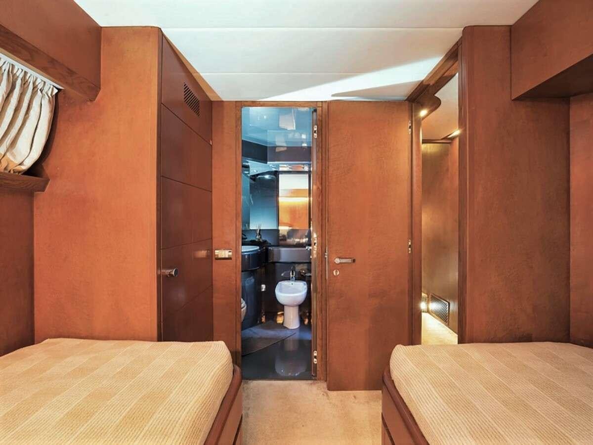 a room with a bed and a table aboard CLAUDIA AMBER Yacht for Charter