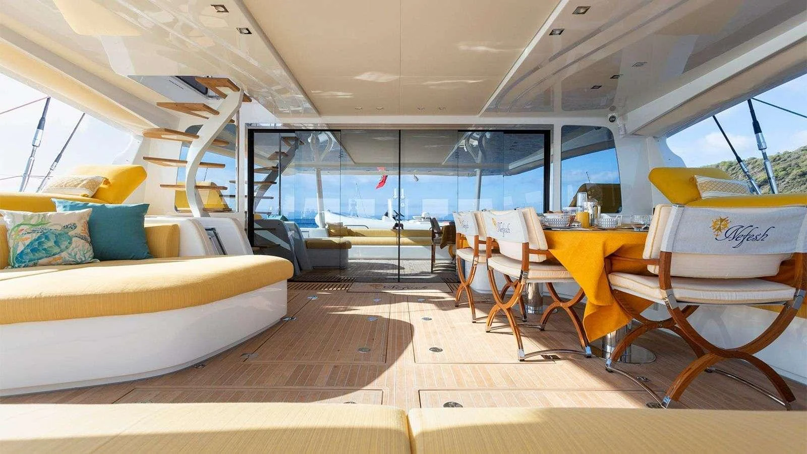 The aft deck features a spacious and elegant dining area with a seamless transition to the outdoor lounging space. aboard NEFESH Yacht for Charter
