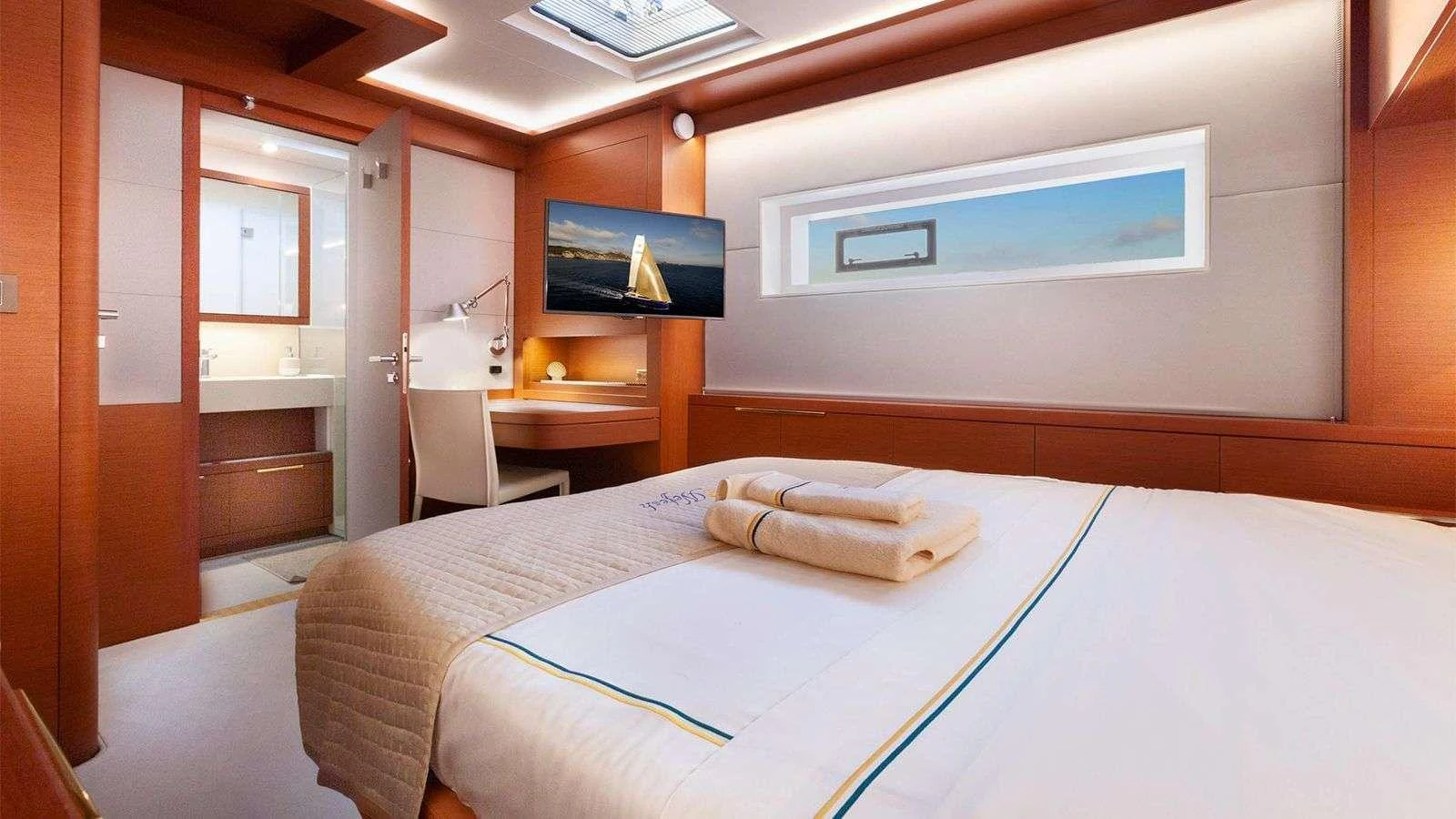 The stateroom features a comfortable bed, modern furnishings, and a private ensuite bathroom. aboard NEFESH Yacht for Charter