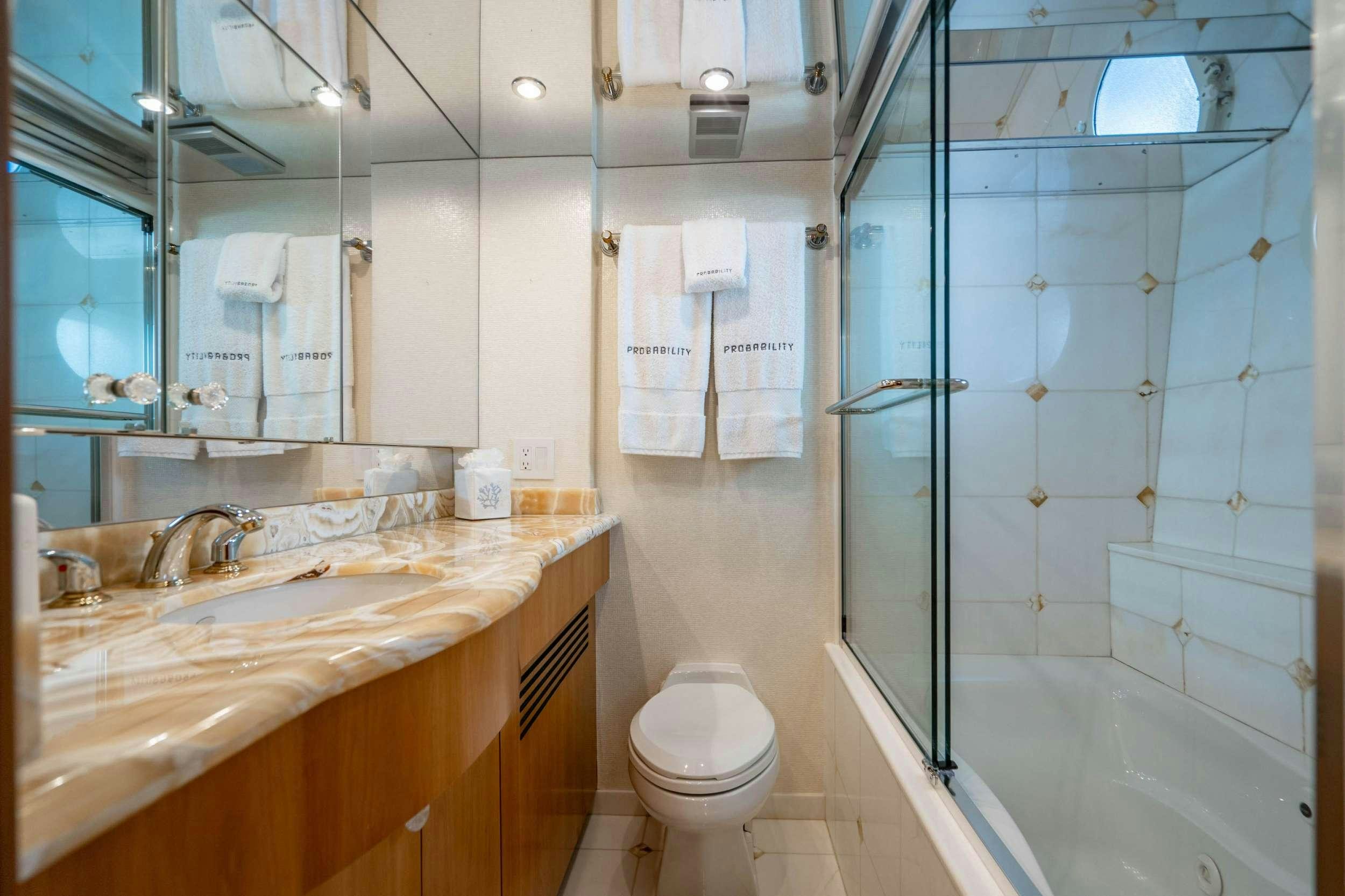 a bathroom with a glass shower aboard INEVITABLE Yacht for Charter