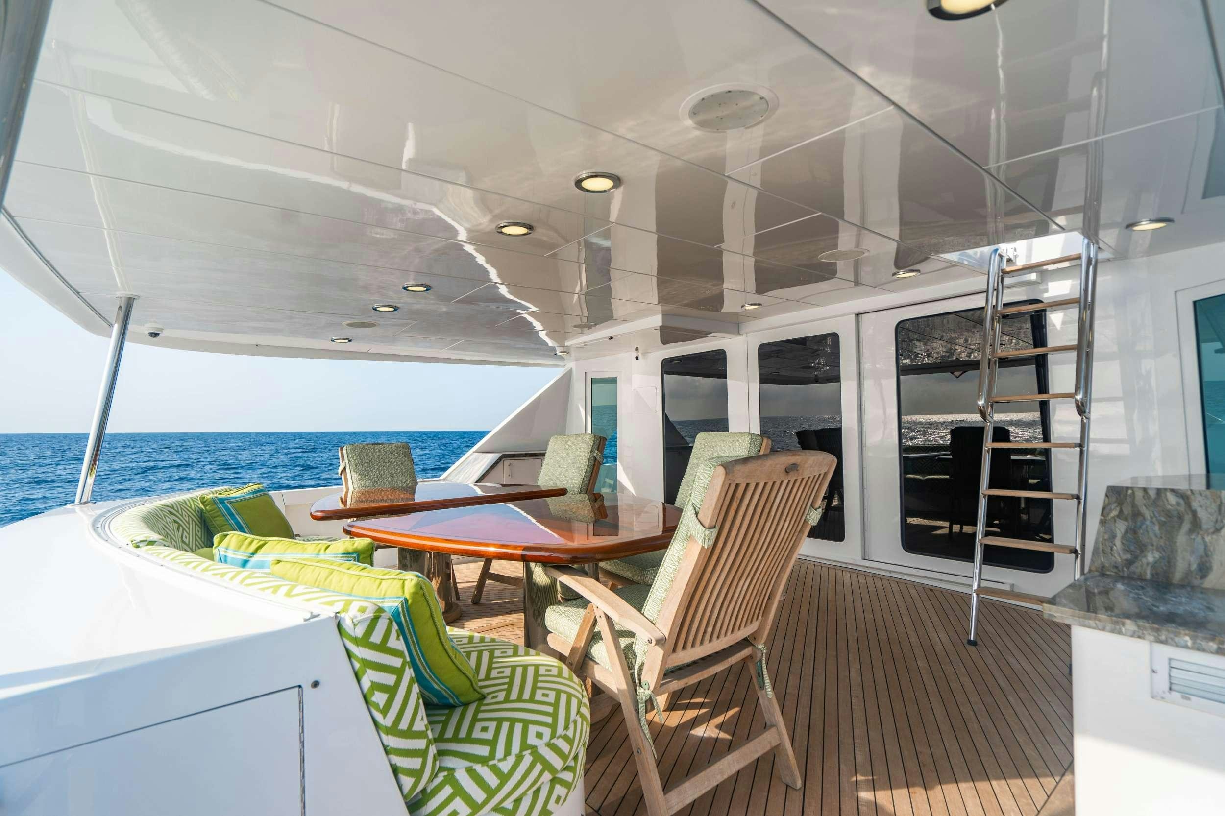 a boat with a table and chairs aboard INEVITABLE Yacht for Charter