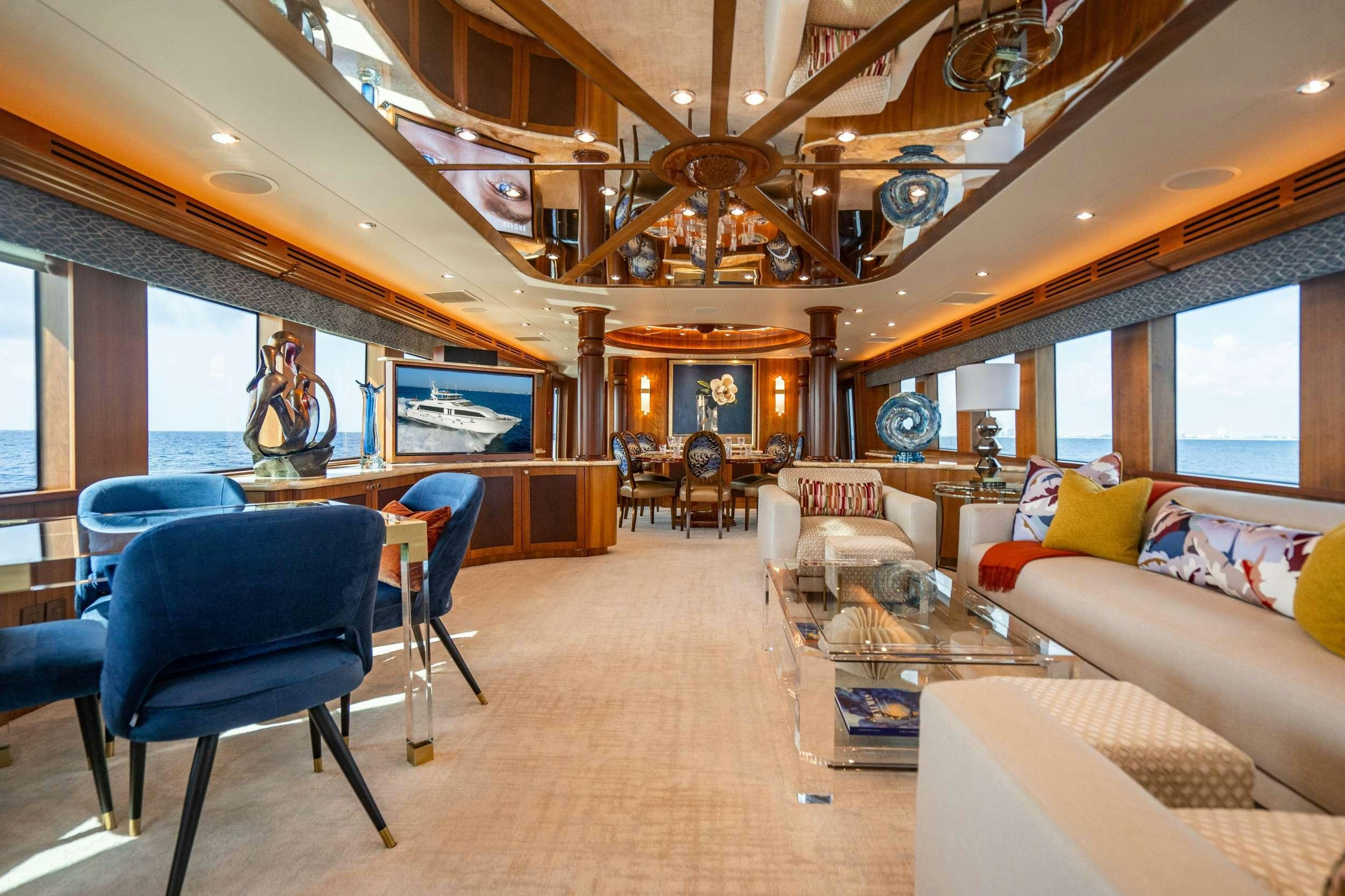 a room with a couch and a table and chairs aboard INEVITABLE Yacht for Charter