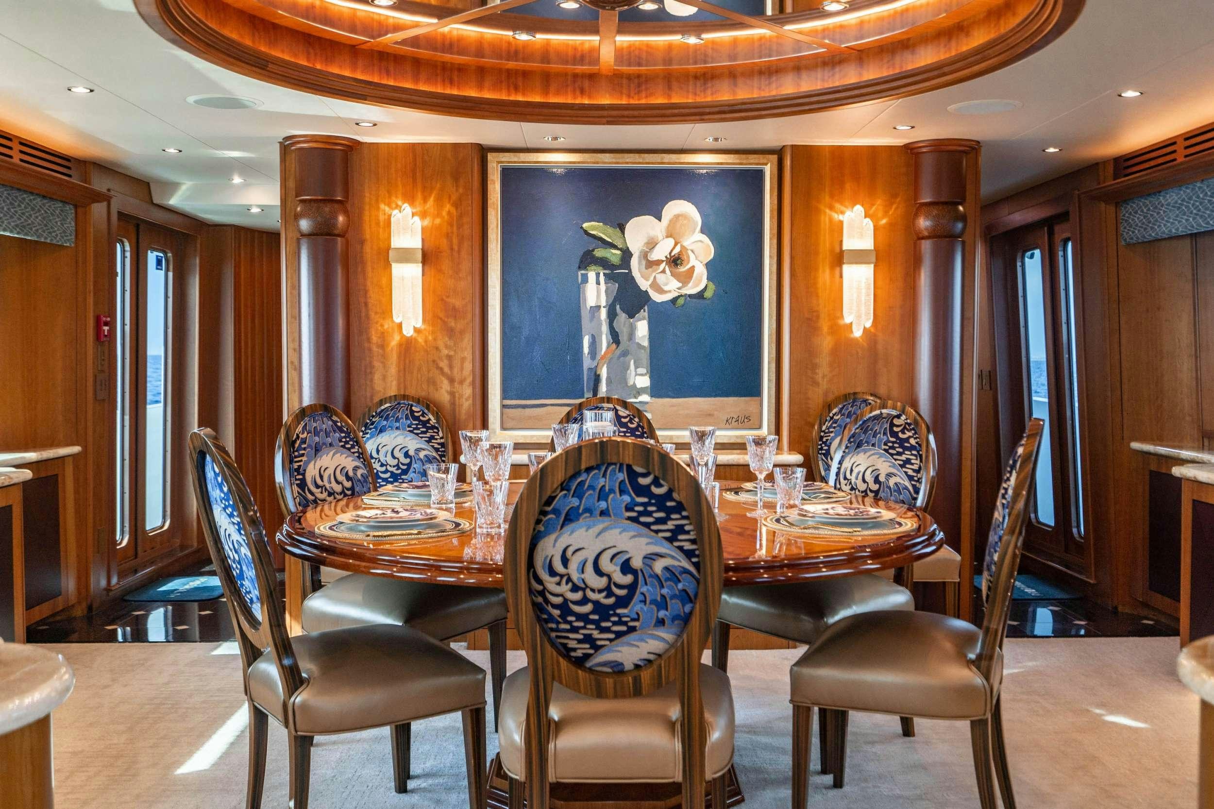 a dining room with a table and chairs aboard INEVITABLE Yacht for Charter