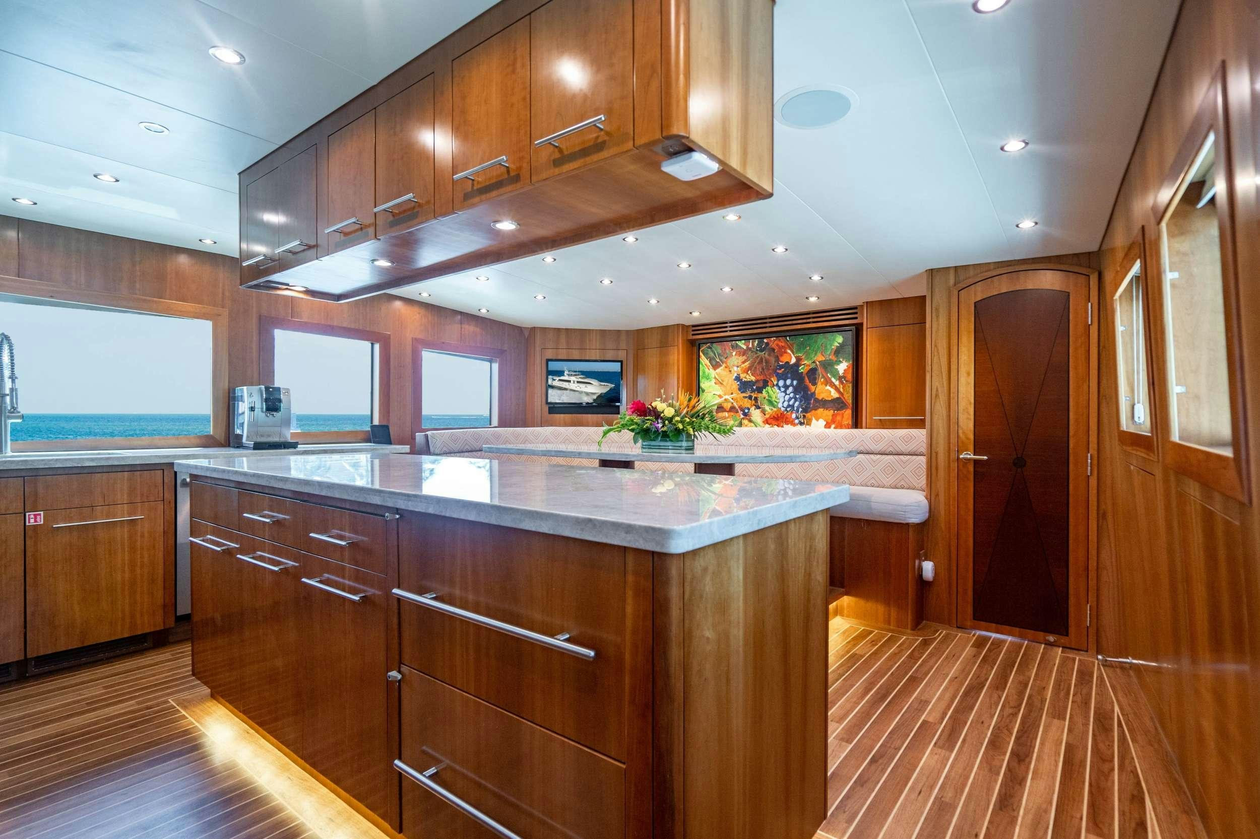a kitchen with wooden cabinets aboard INEVITABLE Yacht for Charter