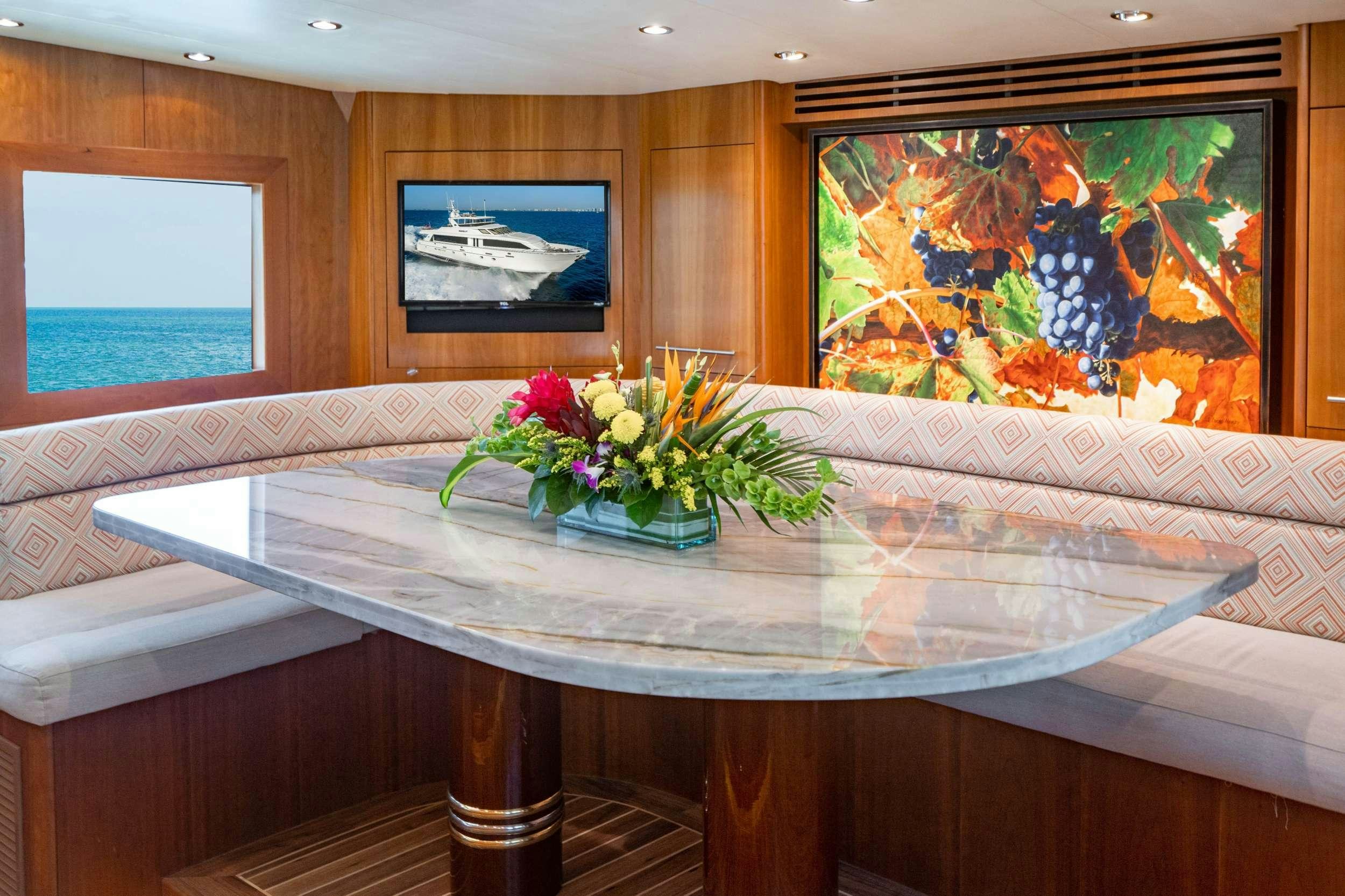 a table with flowers on it aboard INEVITABLE Yacht for Charter