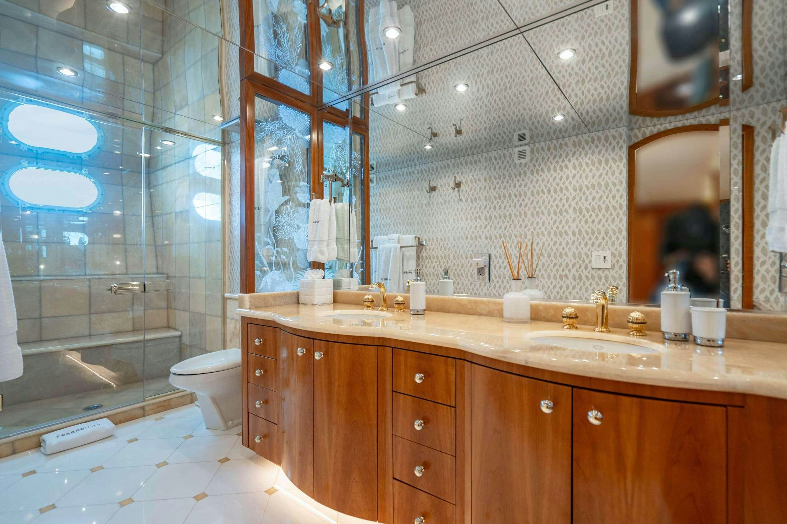 a bathroom with a glass shower aboard INEVITABLE Yacht for Charter