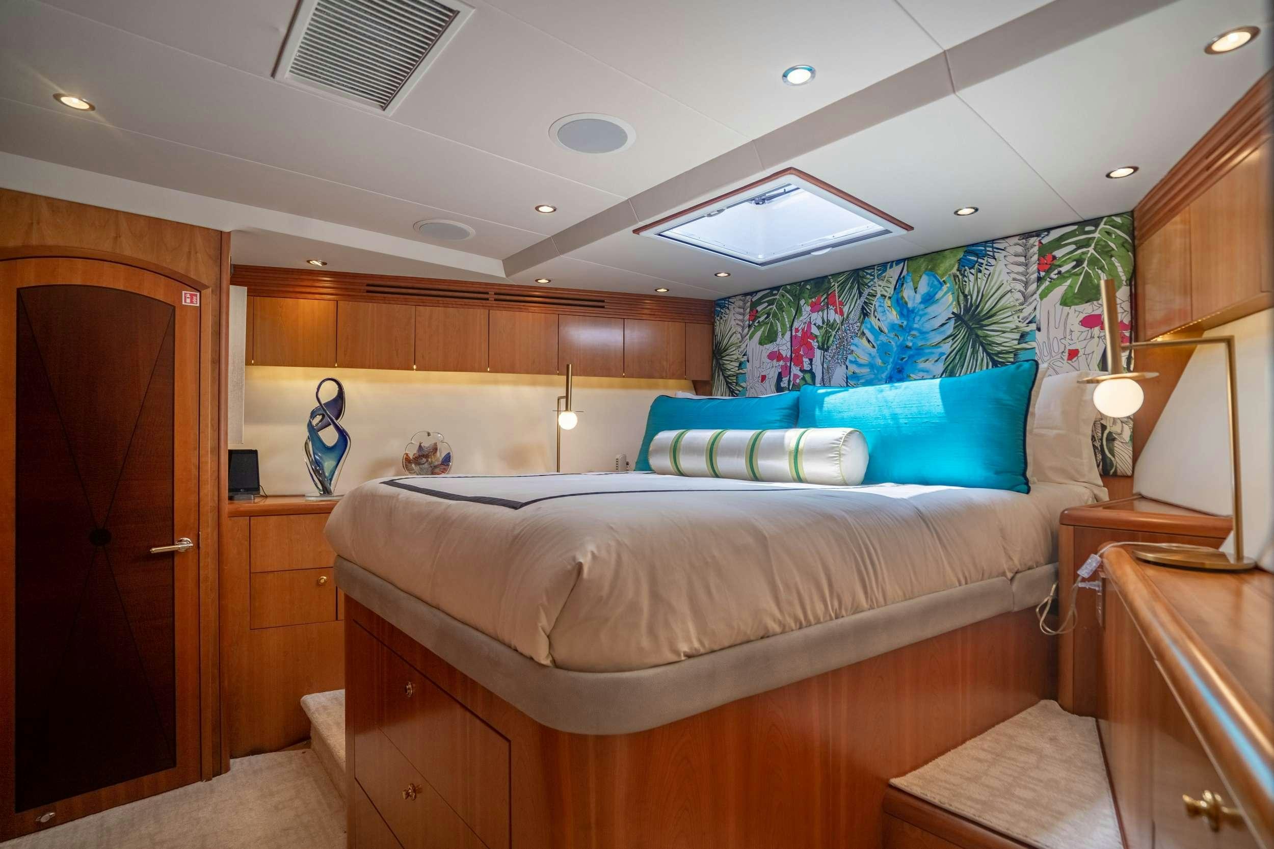 a bedroom with a bed and a desk aboard INEVITABLE Yacht for Charter