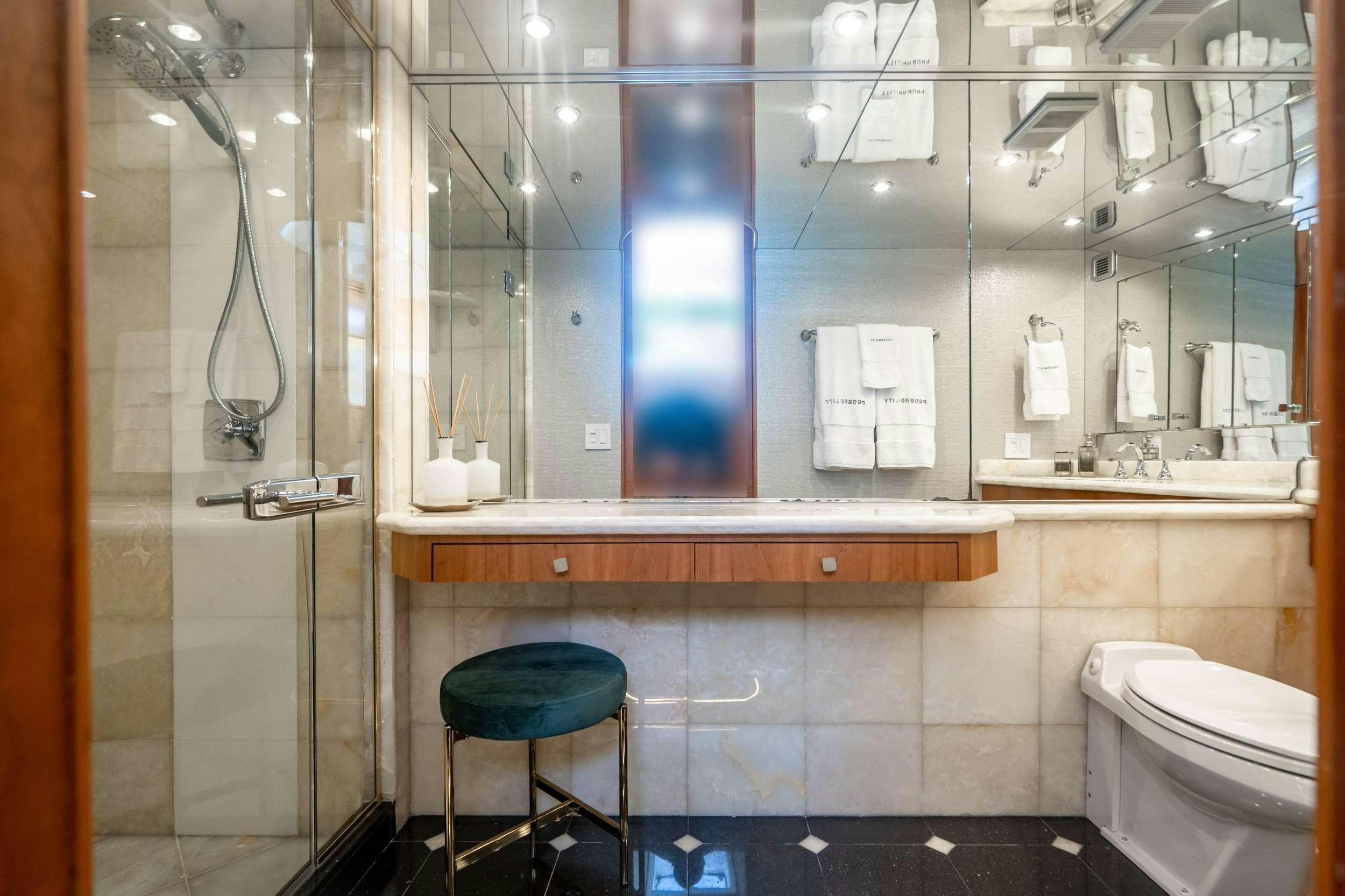 a bathroom with a glass shower aboard INEVITABLE Yacht for Charter