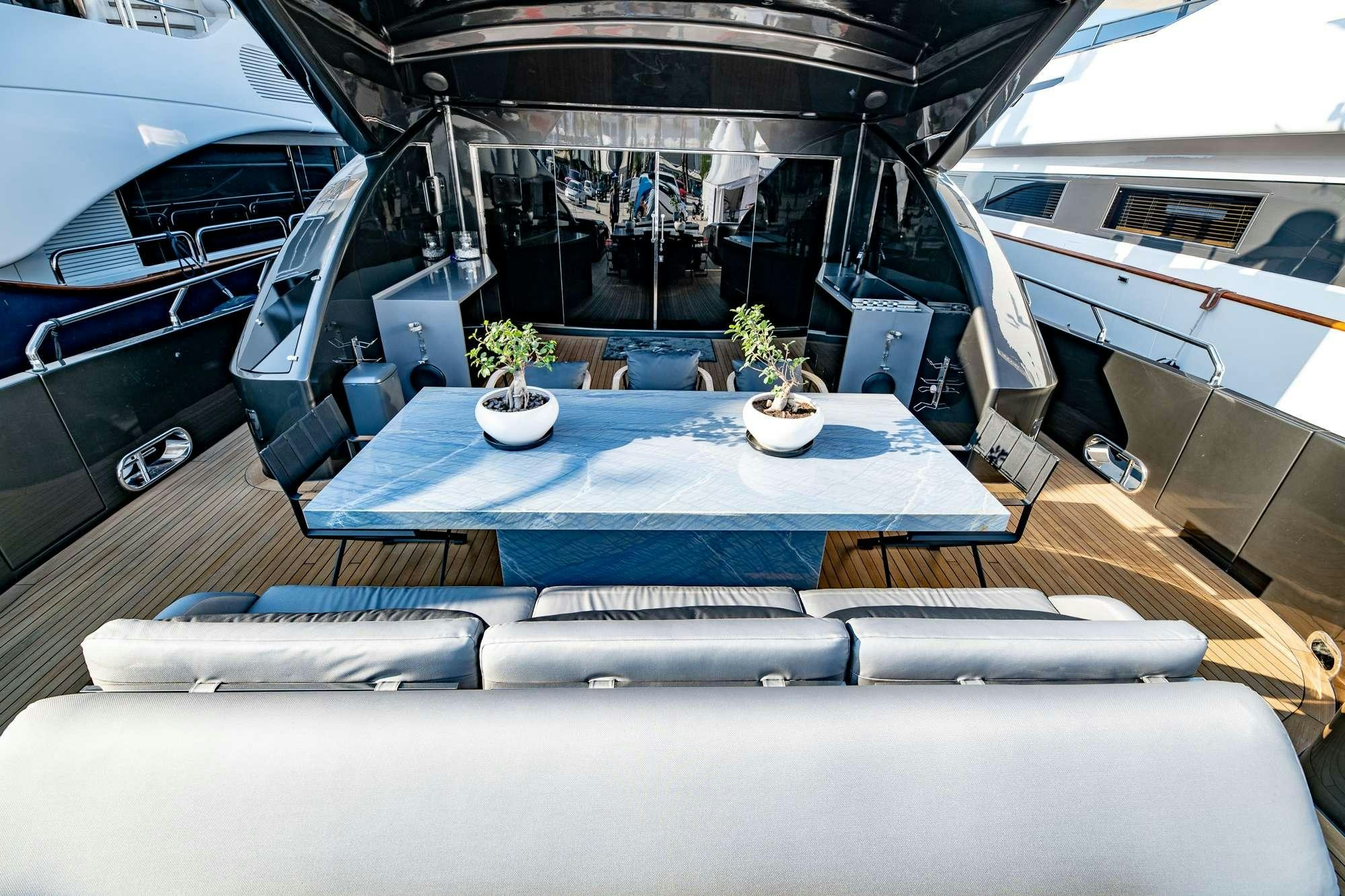 a boat with a table and chairs aboard EVA Yacht for Charter