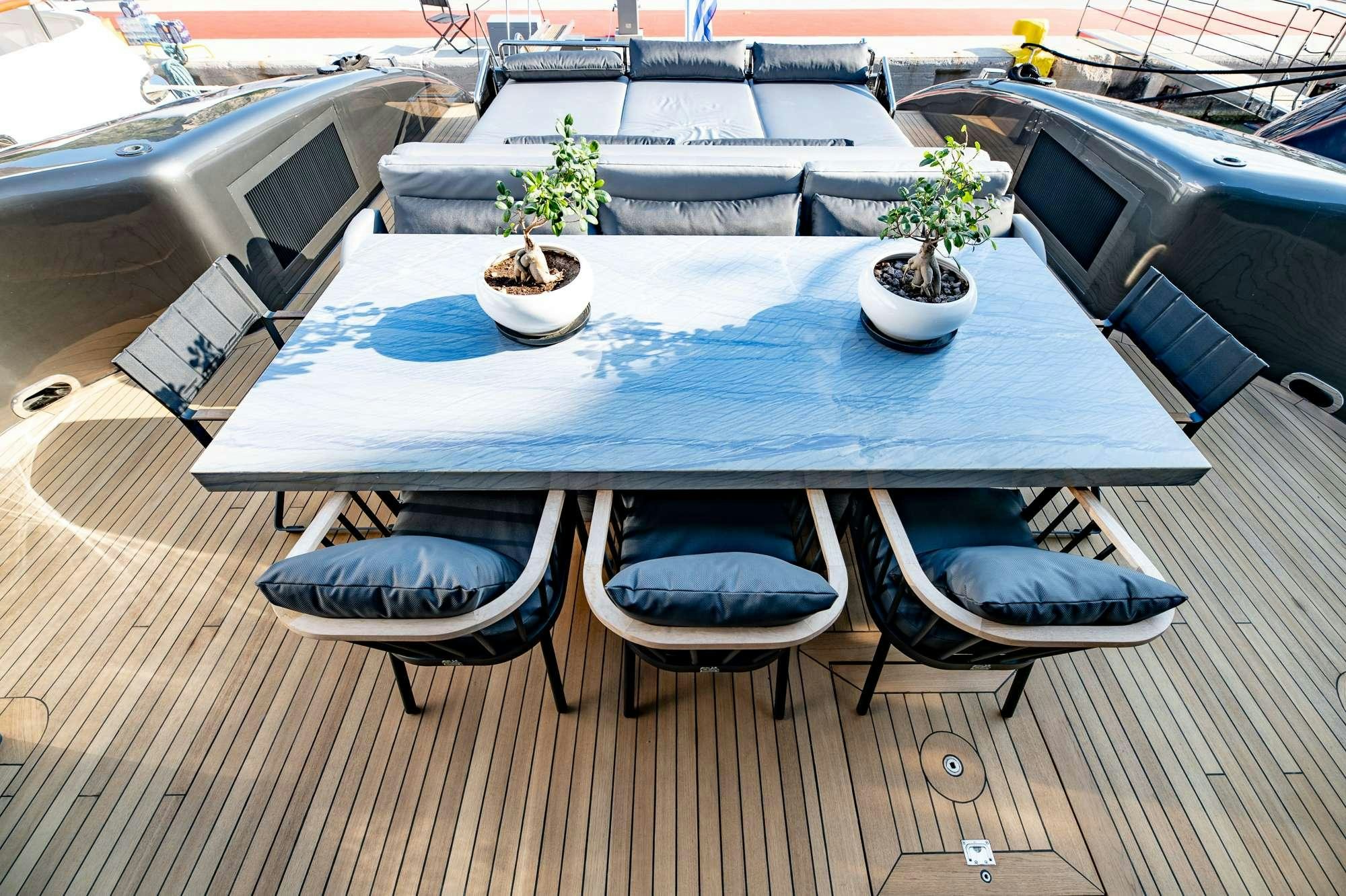 a table with chairs around it aboard EVA Yacht for Charter