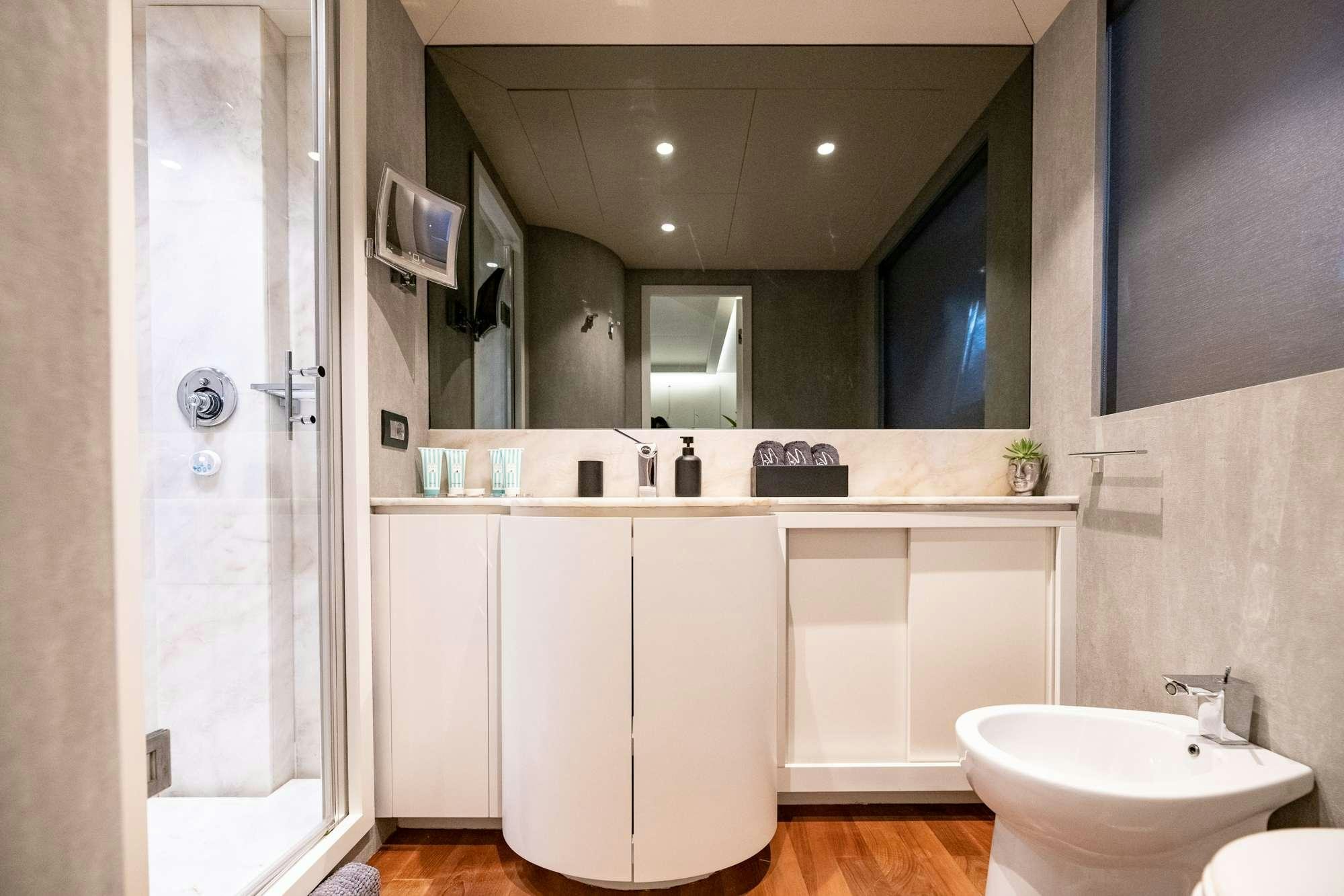 a bathroom with a large mirror aboard EVA Yacht for Charter