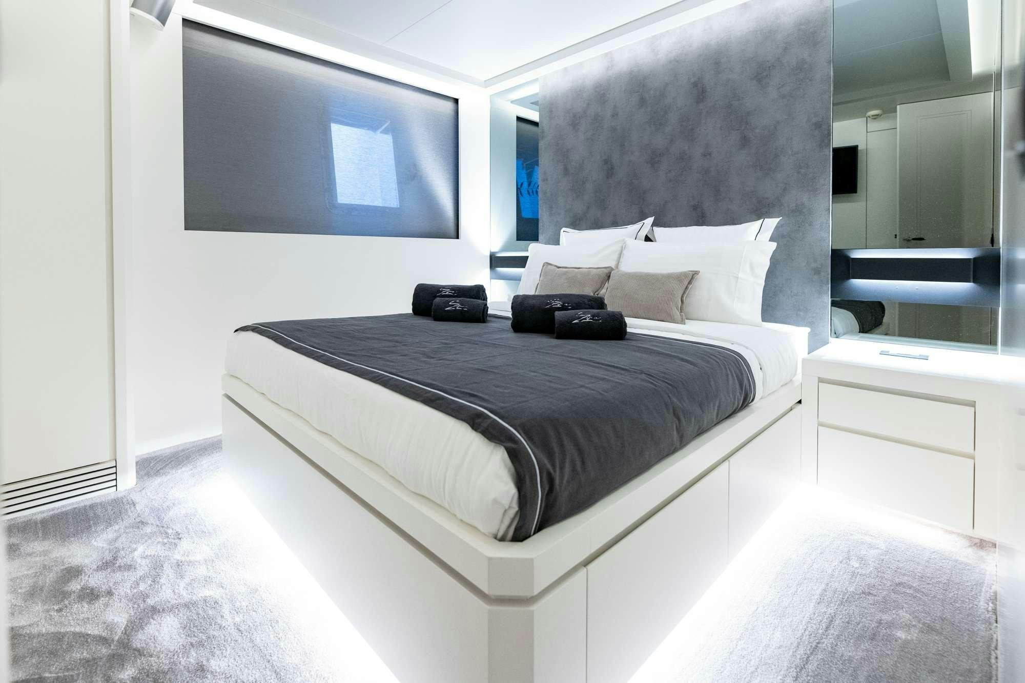a bed with a black pillow aboard EVA Yacht for Charter