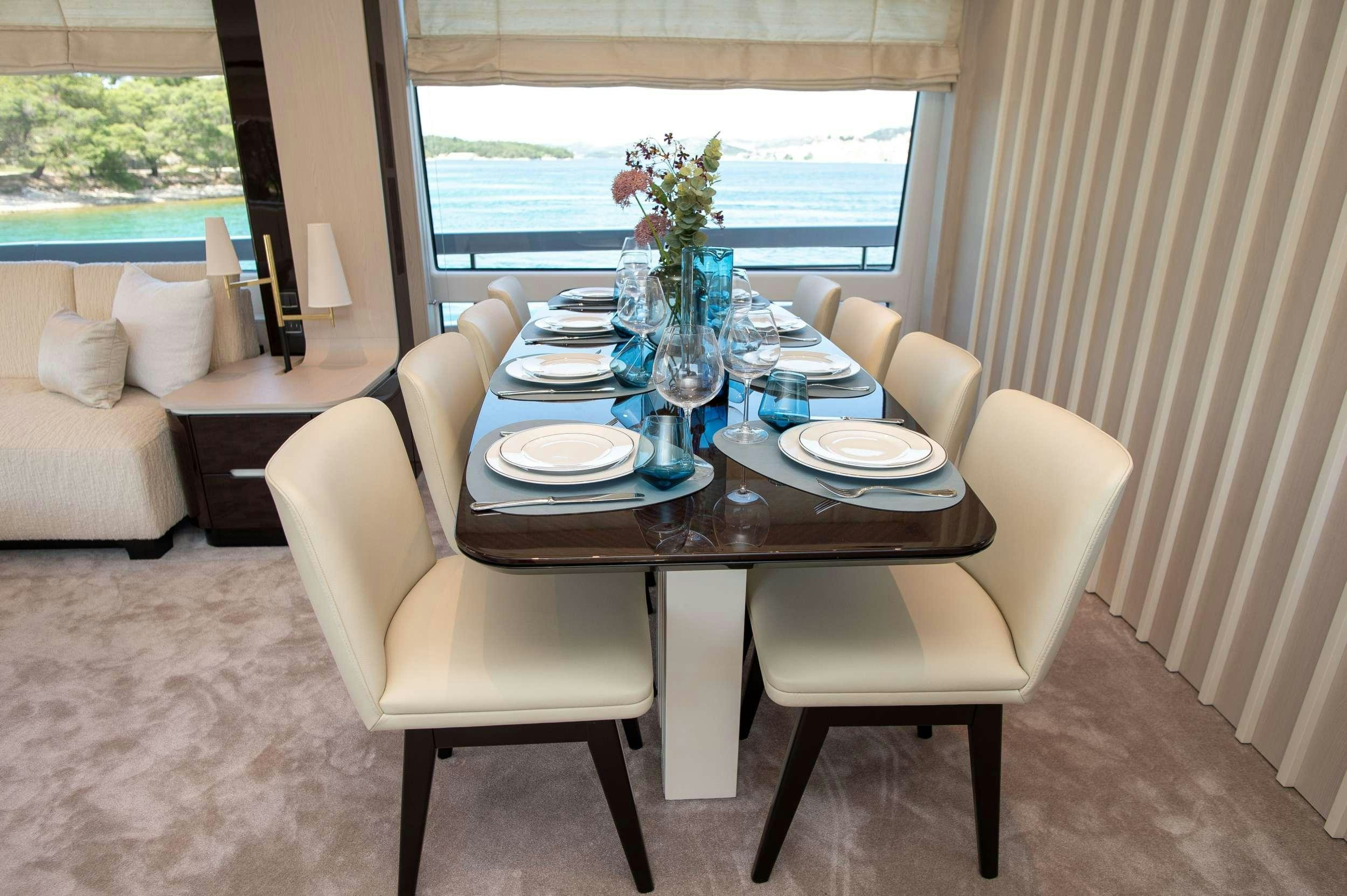 a table with plates and glasses on it aboard PREWI Yacht for Charter