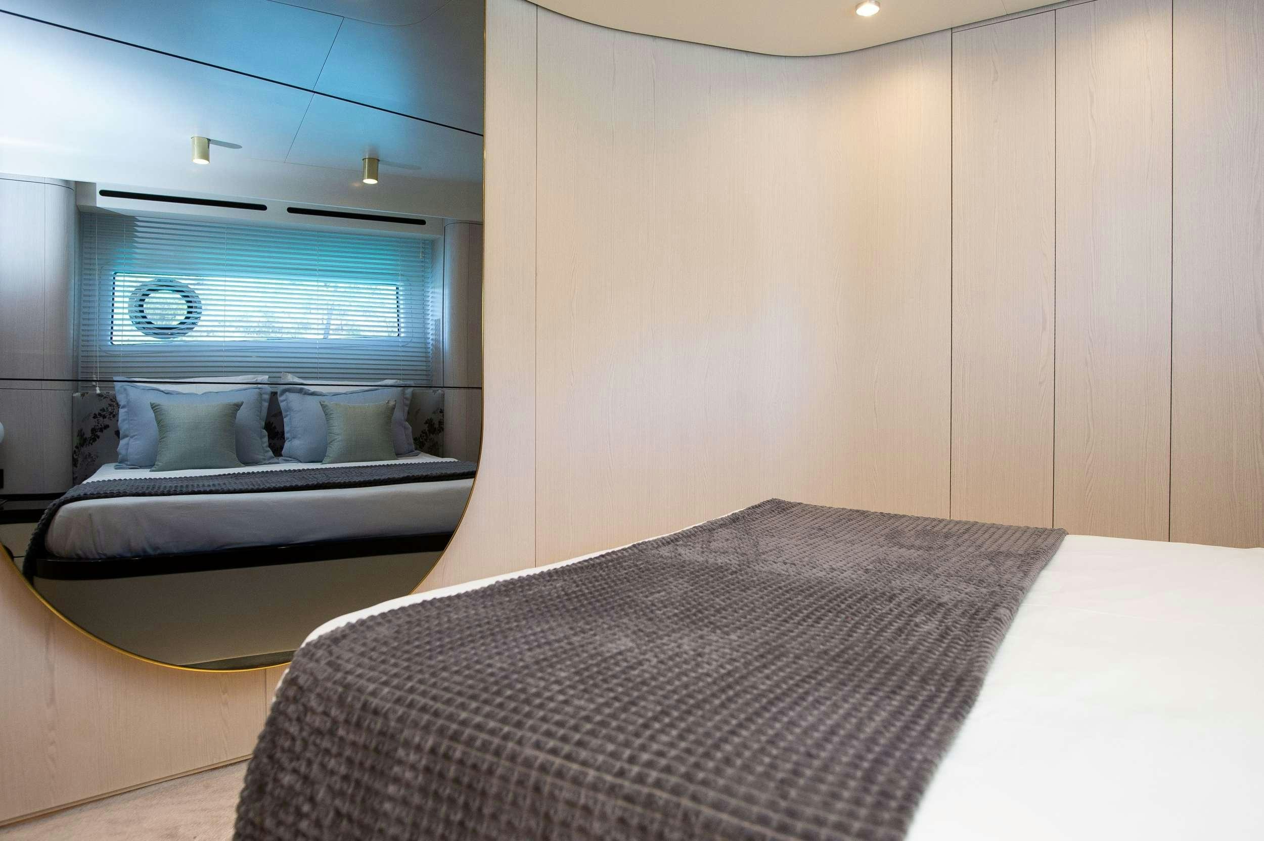 a bed with a television on the wall aboard PREWI Yacht for Charter