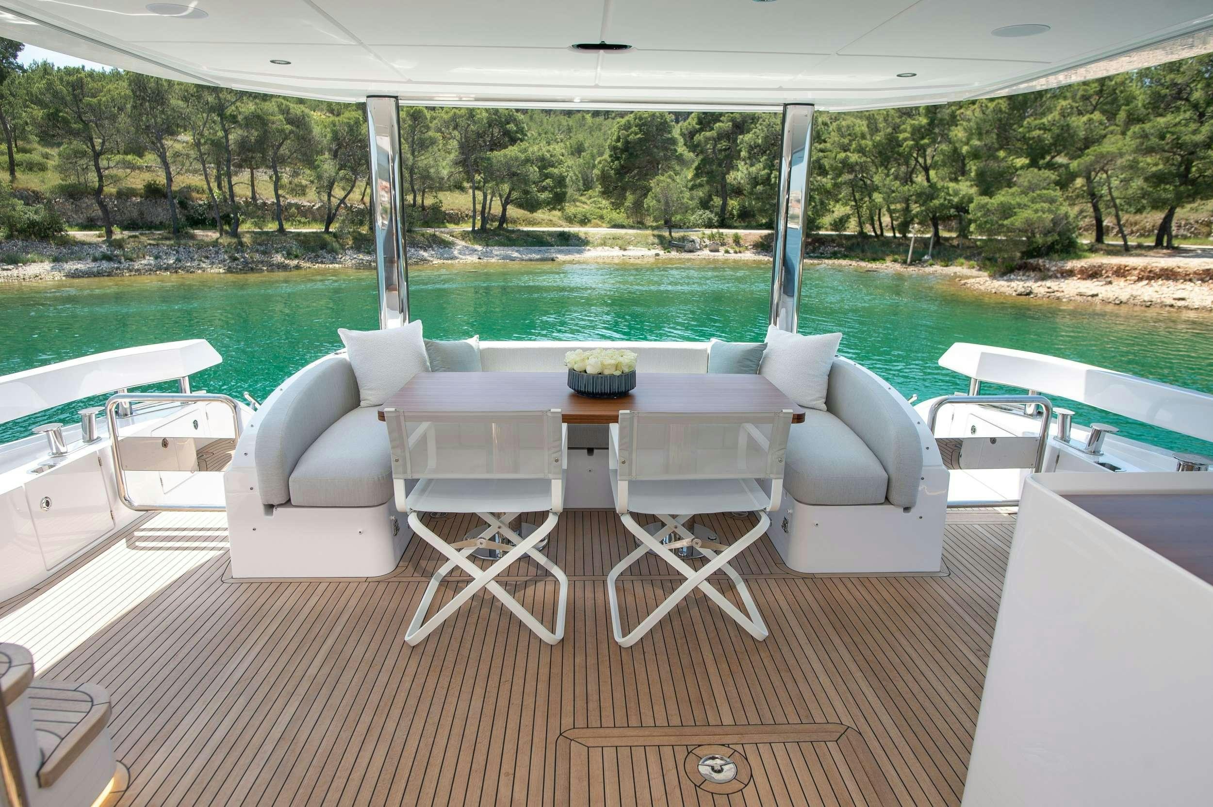 a deck with chairs and tables aboard PREWI Yacht for Charter