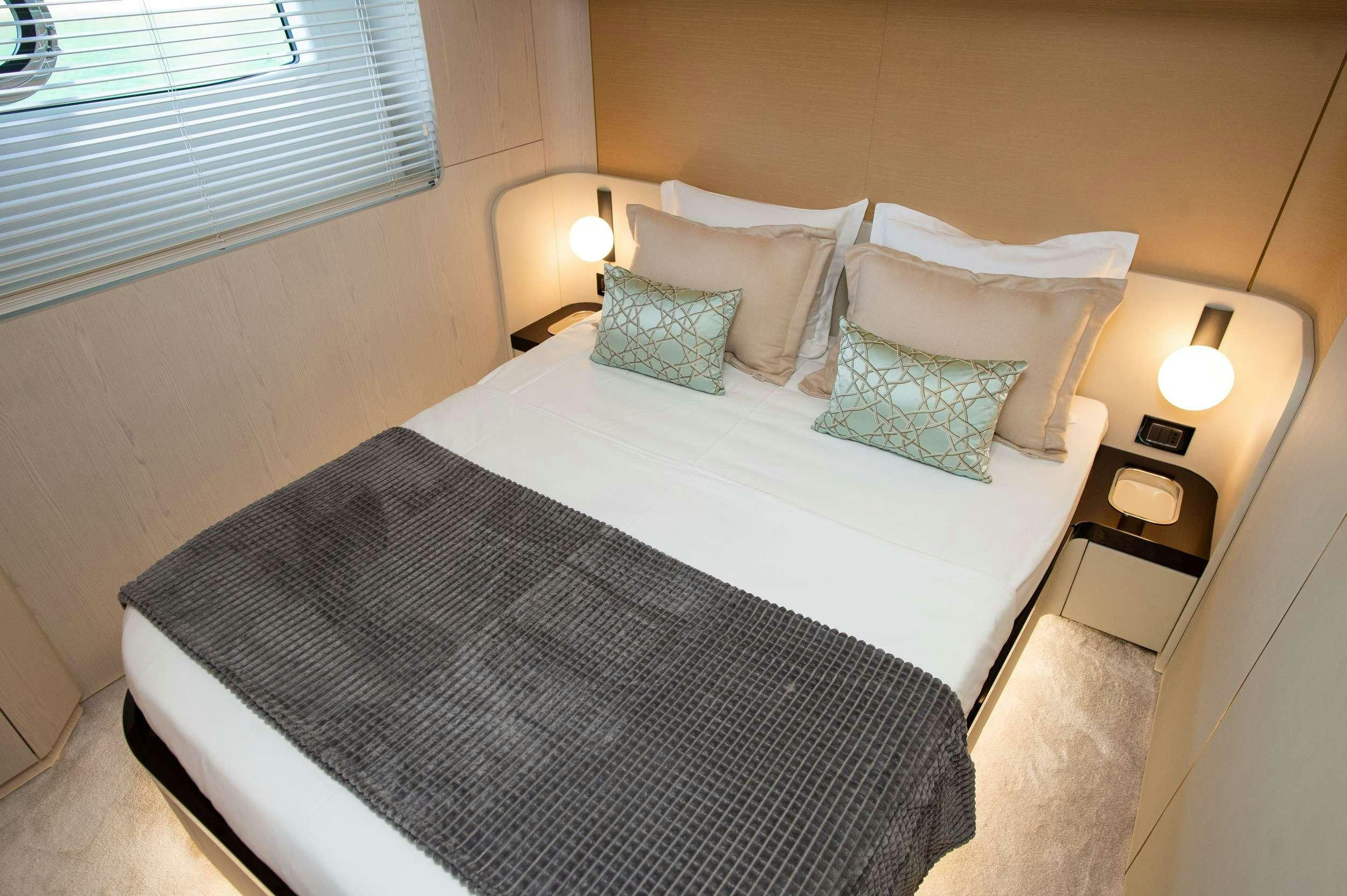 a bed with pillows aboard PREWI Yacht for Charter