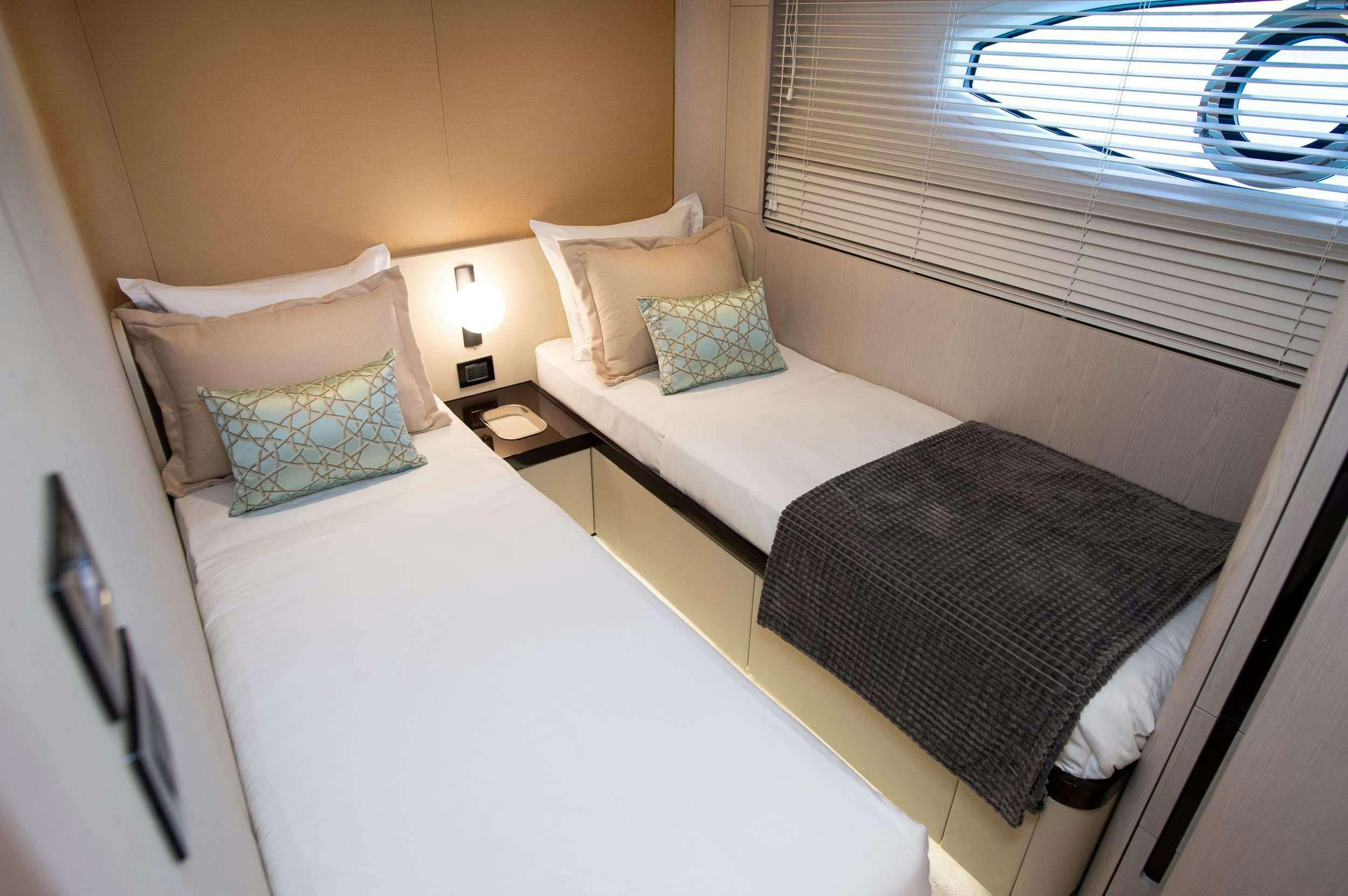 a couple of beds in a hotel room aboard PREWI Yacht for Charter