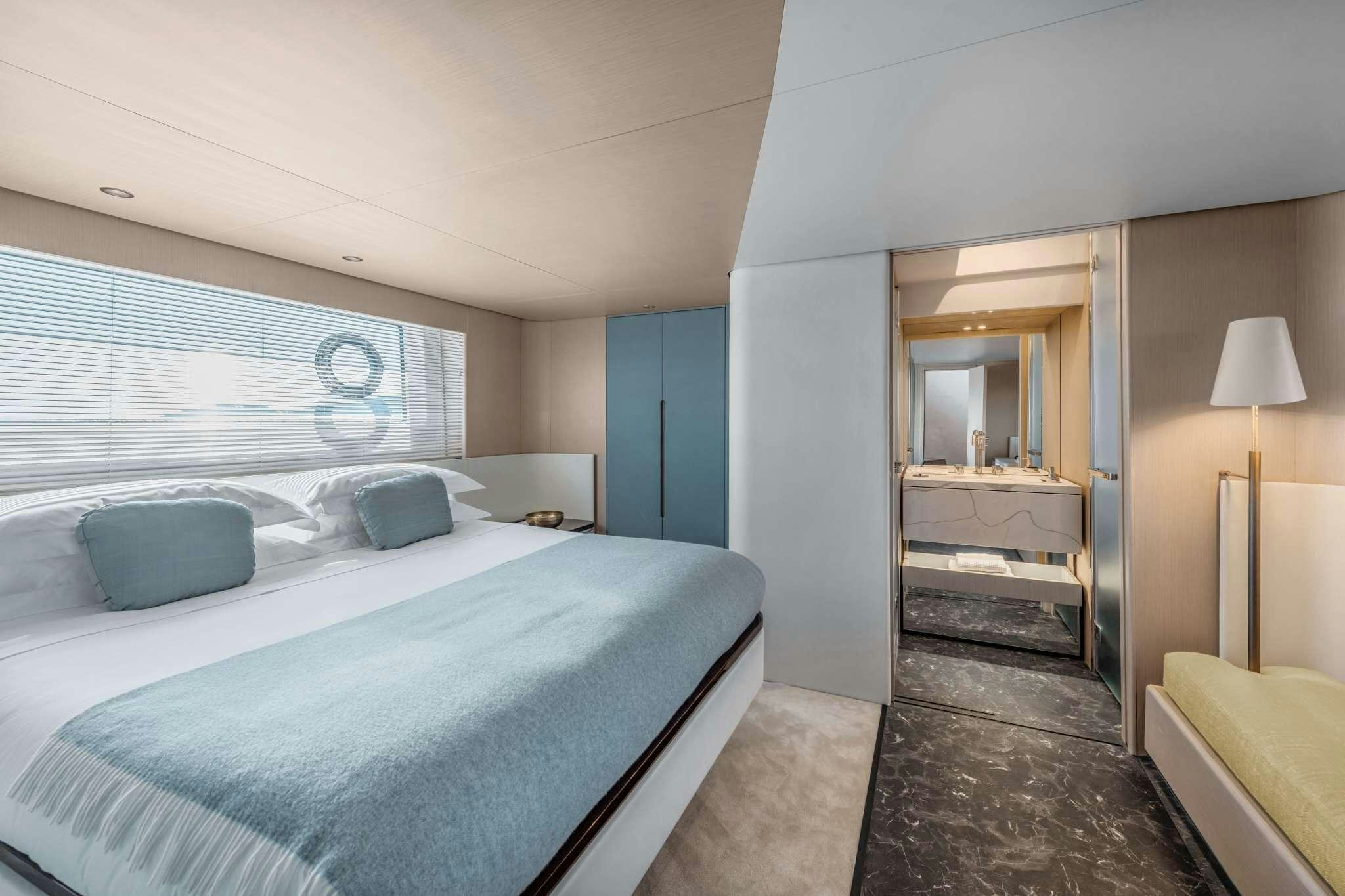 a bedroom with a bed and a desk aboard DONNA Yacht for Charter