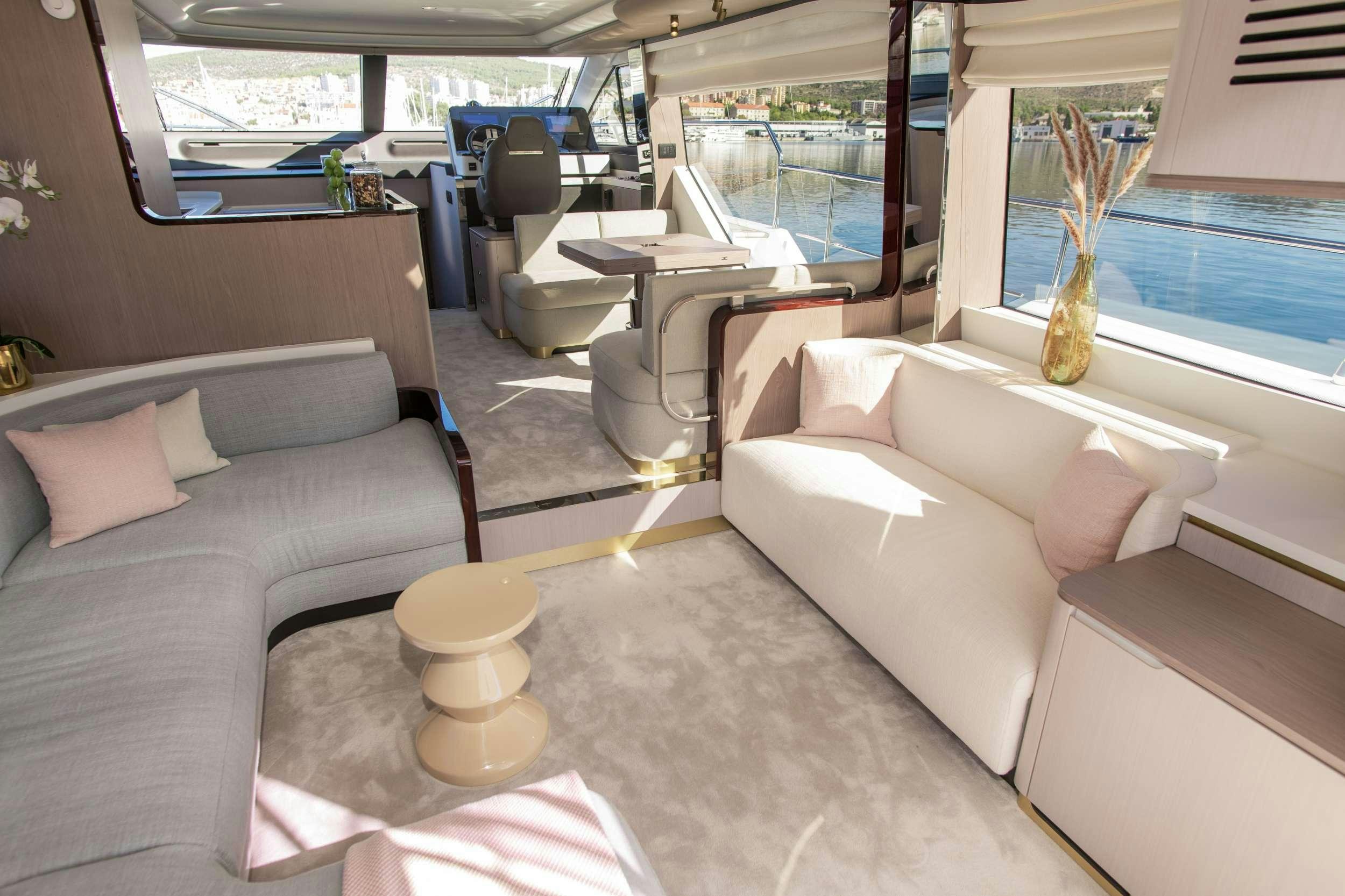 a room with couches and a table aboard ALIBABA Yacht for Charter