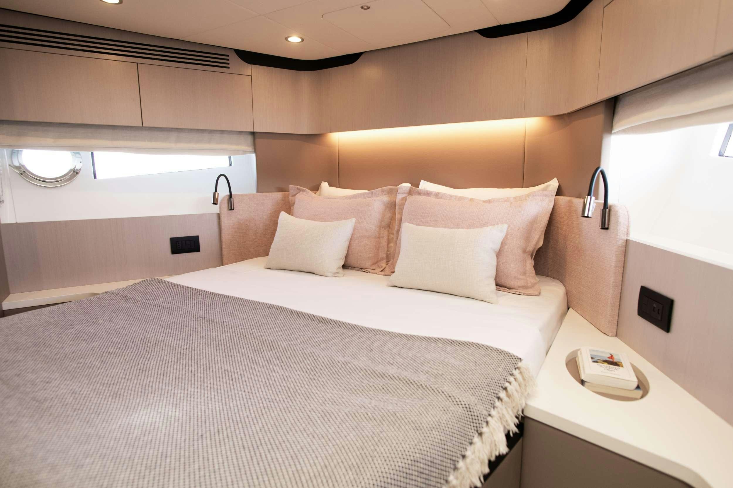 a bed with white pillows aboard ALIBABA Yacht for Charter